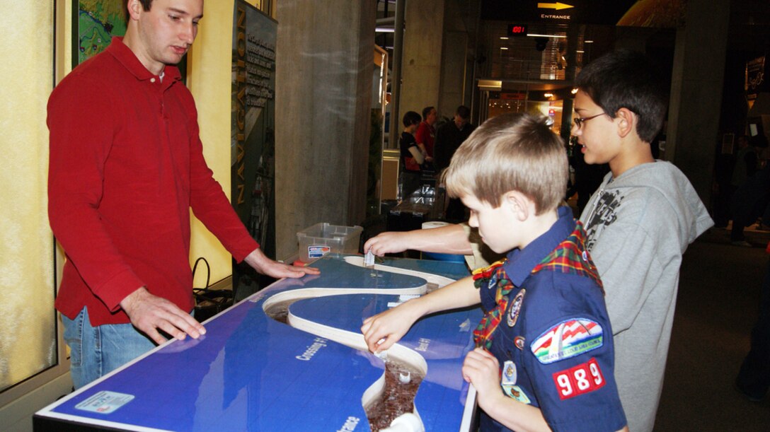 ST. LOUIS, Mo. — U.S. Army Corps of Engineers' Bryan Dirks explains the science behind building a levee to children Feb. 25 during Engineer Week at the St. Louis Science Center.