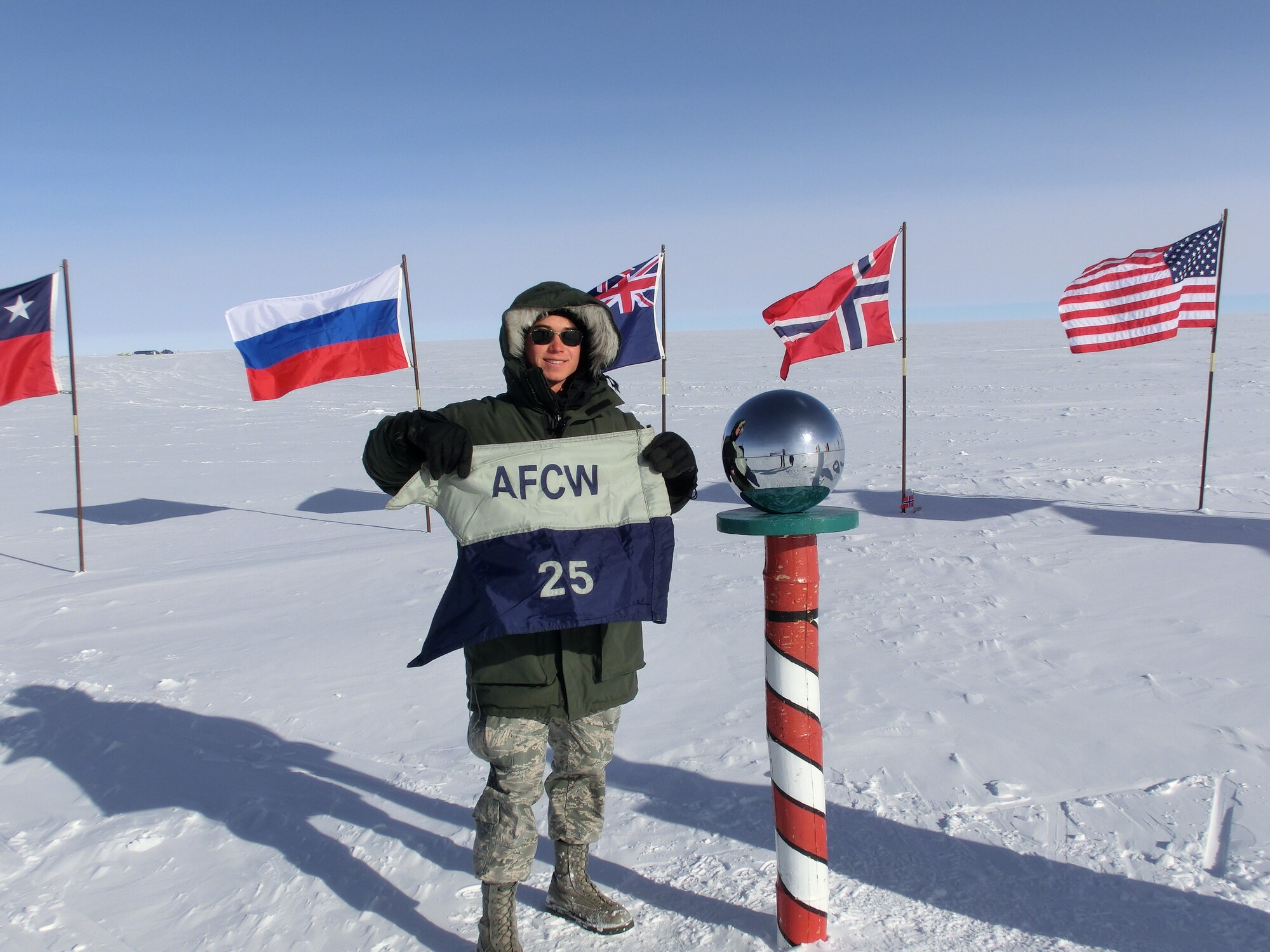 U.S. Air Force Academy Cadet 1st Class Joshua Linsell, meteorology major, holds the Cadet Squadron 25 guidon at the South Pole in -18 degree temps. Linsell visited Antarctica in December as part of a joint U.S. Antarctic Program and Air Force’s Nation Science Foundation trip. (Courtesy photo)