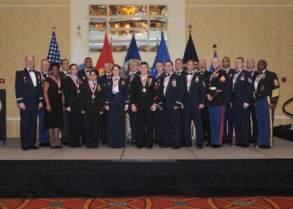 OMAHA, Neb. - Gen. C. Robert Kehler, Commander, U.S. Strategic Command, and Command Sgt. Maj. Patrick Alston, Senior Enlisted Leader, USSTRATCOM, take a group photo with award recipients from the 2011 USSTRATCOM Annual Awards banquet held March 2.