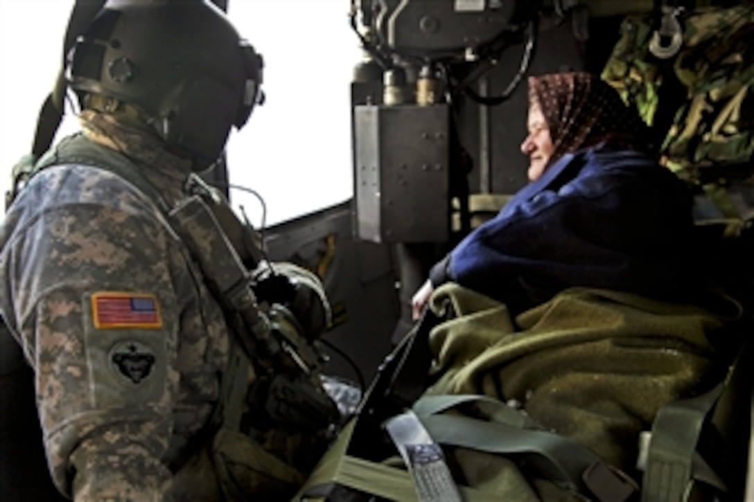 U.S. Army Staff Sgt. Gerald Winchester monitors a Montenegrin citizen during an air medical evacuation over Podgorica, Montenegro, Feb. 28, 2012. U.S. soldiers helped provide humanitarian assistance at the request of Montenegro's government in response to heavy snowfall in the region.
