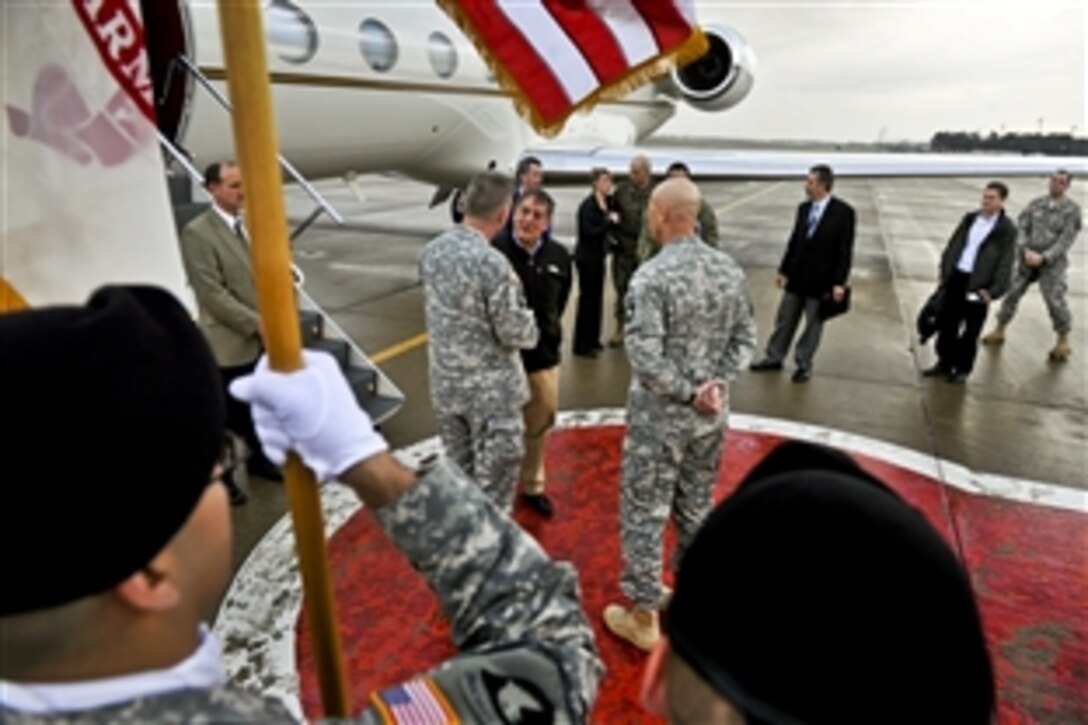 Under stormy skies, Defense Secretary Leon E. Panetta talks to base commanders as he arrives on Fort Campbell, Ky., March 2, 2012.