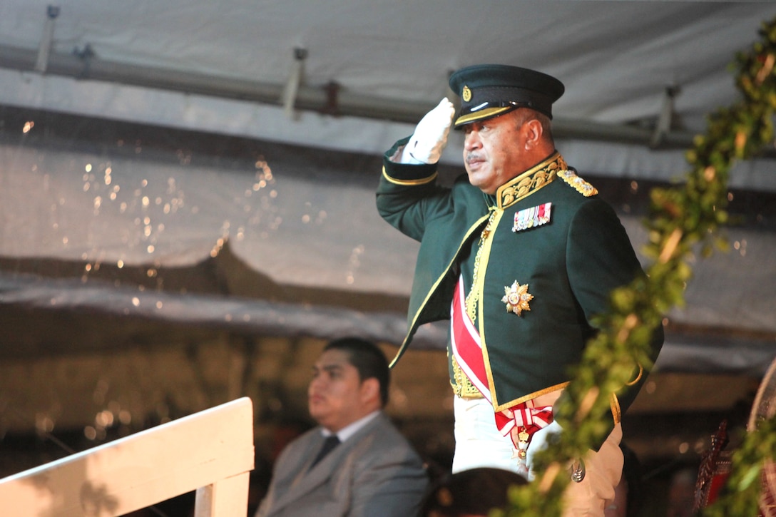 NUKU’ ALOFA, Kingdom of Tonga -His Majesty, King George Tupou V, salutes the U.S. Marine Corps Forces, Pacific, band officer after the conclusion of the band’s performance during the Kingdom of Tonga Military Parade and Tattoo, Aug. 2. The parade and Tattoo were held in honor of His Majesty’s birthday. A Tattoo is comprised of military units – musical and operational – from different countries collaborating in an extensive exhibition of musical performances and demonstrating military capabilities.