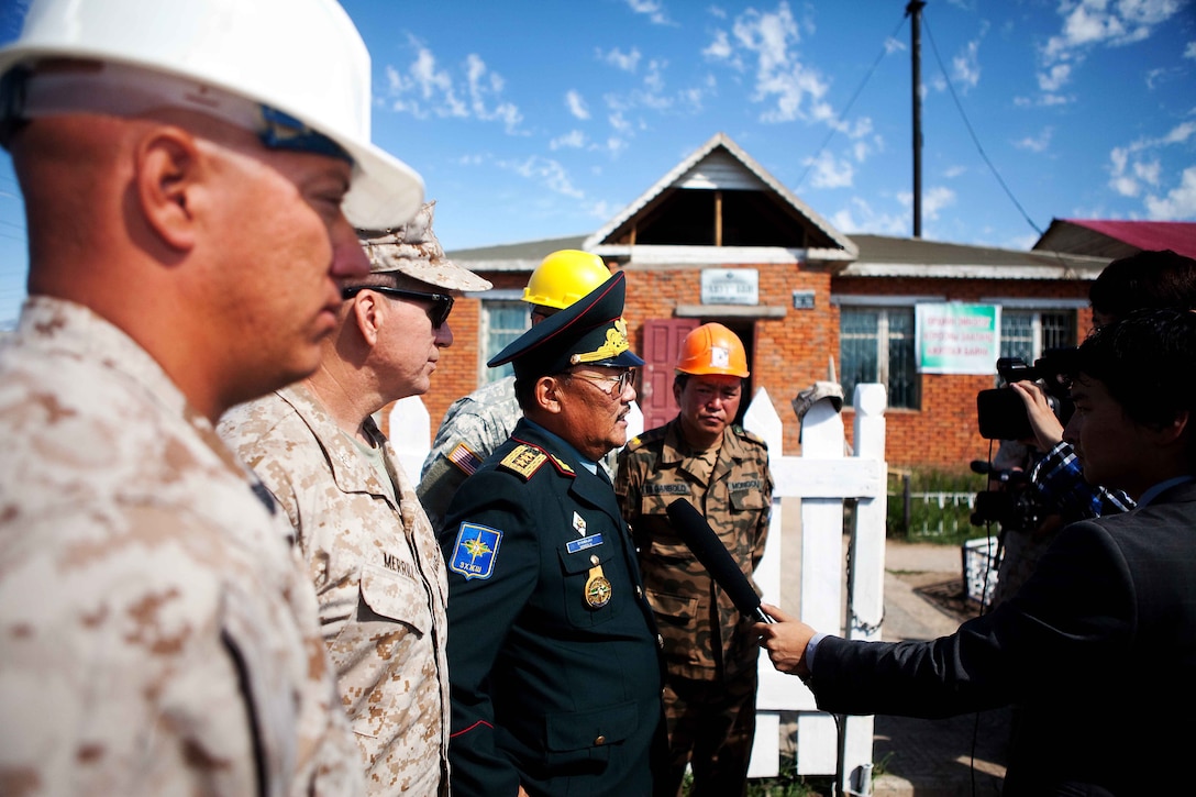 ULAANBAATAR, Mongolia-Lt. Gen. Byambajav Tserendejid, chief of general staff, Mongolian armed forces, and Col. Steven Merrill, U.S. exercise director, Marine Corps Forces, Pacific, speak with local media during the Engineering Civic Action Program during Exercise Khaan Quest 2011 in Ulaanbaatar, Mongolia, Aug. 1. The purpose of the program is to improve medical care in the area by adding on to the Ayut Family Hospital, a 17,000 sq. ft. urgent care clinic, which will serve the 9th sub-district of khaan-Uul District. Khaan Quest is a training exercise designed to strengthen the capabilities of U.S., Mongolian and other participating nations’ forces in international peace support operations and civic outreach programs worldwide.
