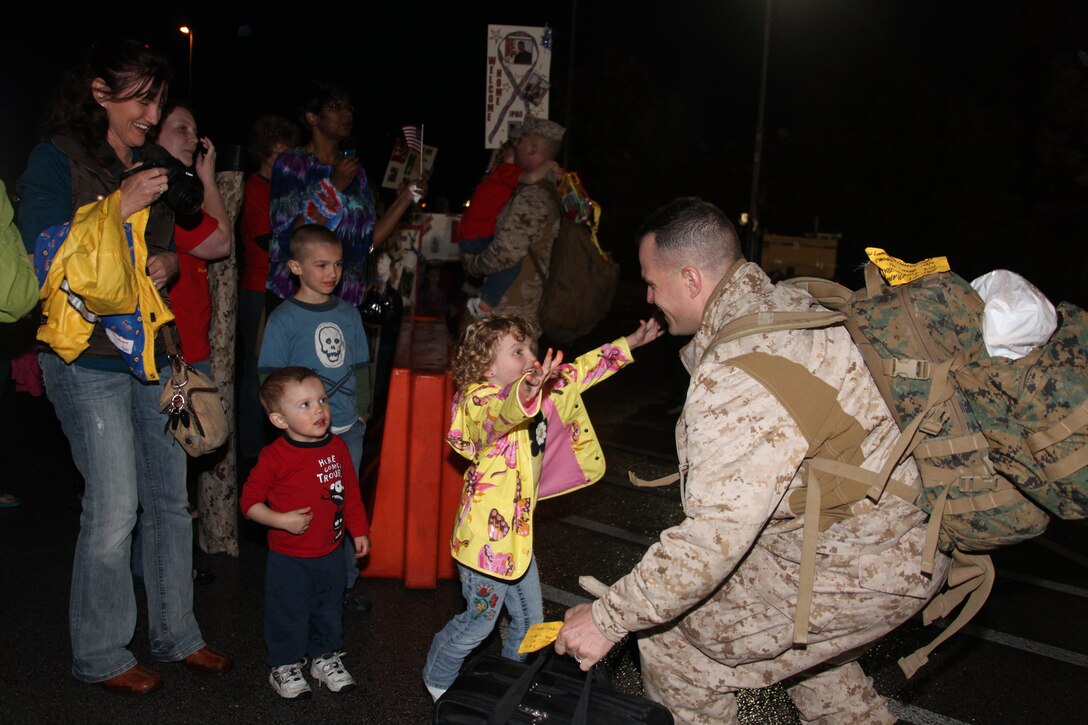 Caitlin Murphy, 4, rushes to embrace her father, Maj. Jeffrey T. Murphy, Saturday, after a more than a yearlong deployment to Afghanistan with the 2nd Marine Aircraft Wing (Forward). Murphy is the aviation safety officer for the wing, which flew approximately 70,000 combat sorties in 60,000 hours of flight time.