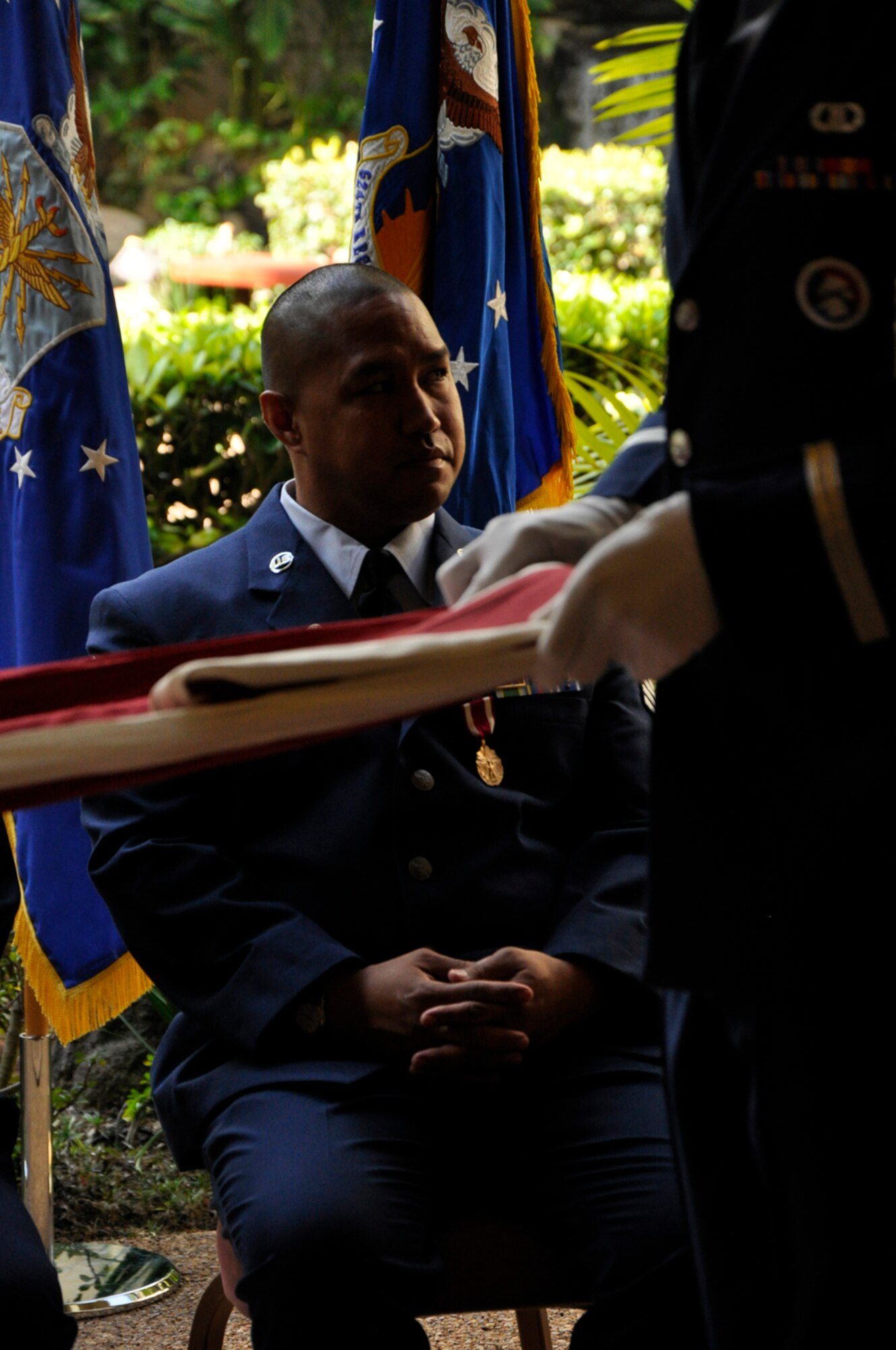 JOINT BASE PEARL HARBOR-HICKAM, Hawaii -- Master Sgt. Homer Keliiwaiwaiole waits as the honor guard folds a flag in commemoration of his retirement from the Air Force Reserve at a ceremony held March 3, 2012, at the Courtyard of Heroes at the Headquarters, Pacific Air Forces building here. Sergeant Keliiwaiwaiole retires after twenty-one years of service. He began life his career as an Air Transportation Specialist with the 48th Aerial Port Squadron in 1992. In 1995 he transferred to what is now known as the 624th Civil Engineer Squadron as a Liquid Fuel System Maintenance Specialist.  During his tenure, Sergeant Keliiwaiwaiole supported military Operations such as “Southern Watch,” “Noble Eagle,” “Cobra Gold,” “Iraqi Freedom,” and “Enduring Freedom.” (U.S. Air Force photo/Master Sgt. Daniel Nathaniel)