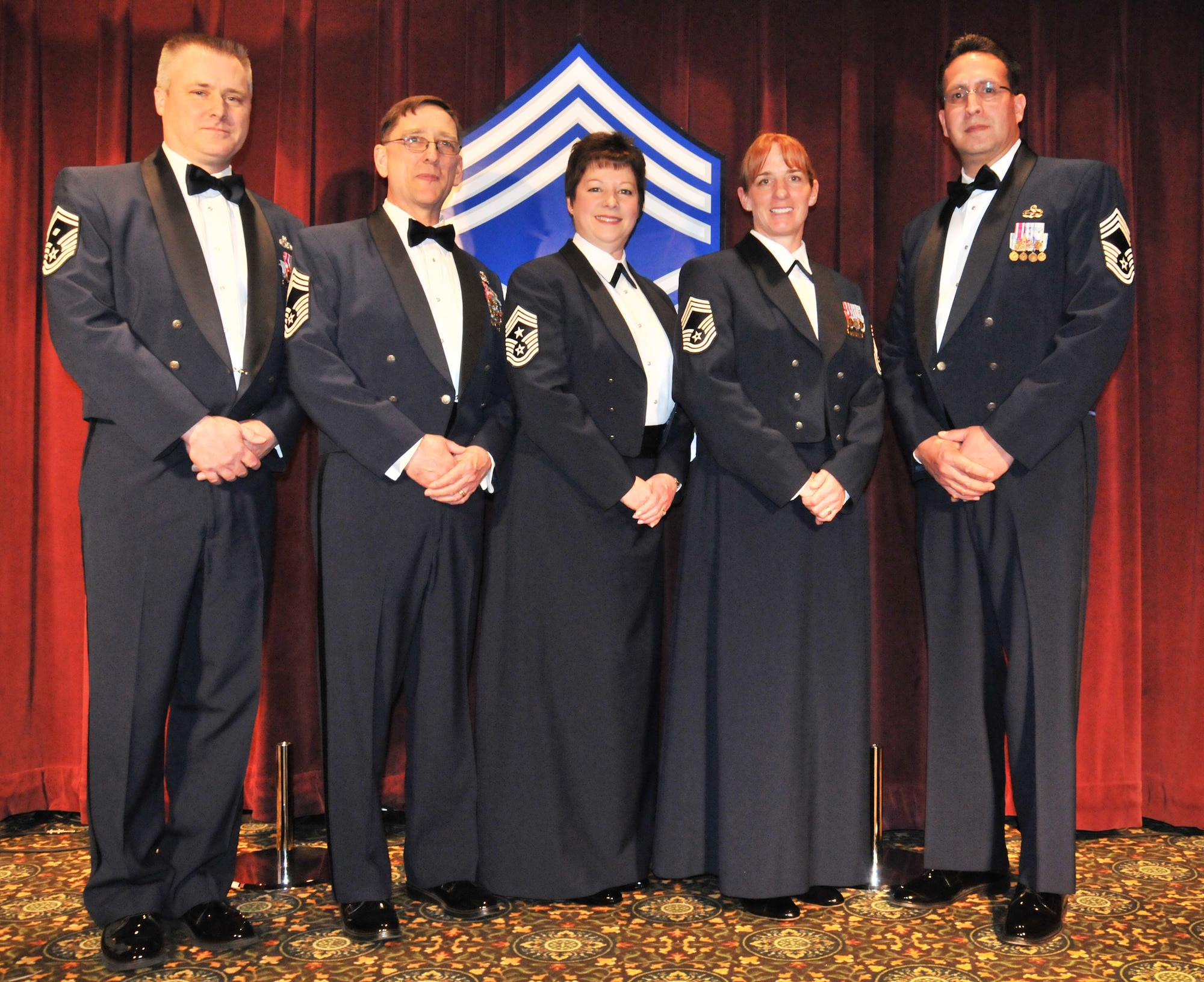 Chief Master Sgt.'s Anthony Mack, Richard Lutz, Gloria Bennett, Shanna Gerard, and Dave Sanchez beam with pride at the Chief's Recognition Ceremony at the McChord Club March 2.  Mack, Lutz, Gerard and Sanchez were inducted as the newest Chief Master Sergeants of the 446th Airlift Wing.  Mack will be replacing Bennet as the new Command Chief.  Bennet will retire April 1 after 33 years of service. (U.S. Air Force photo by 2nd Lt. Denise Hauser)