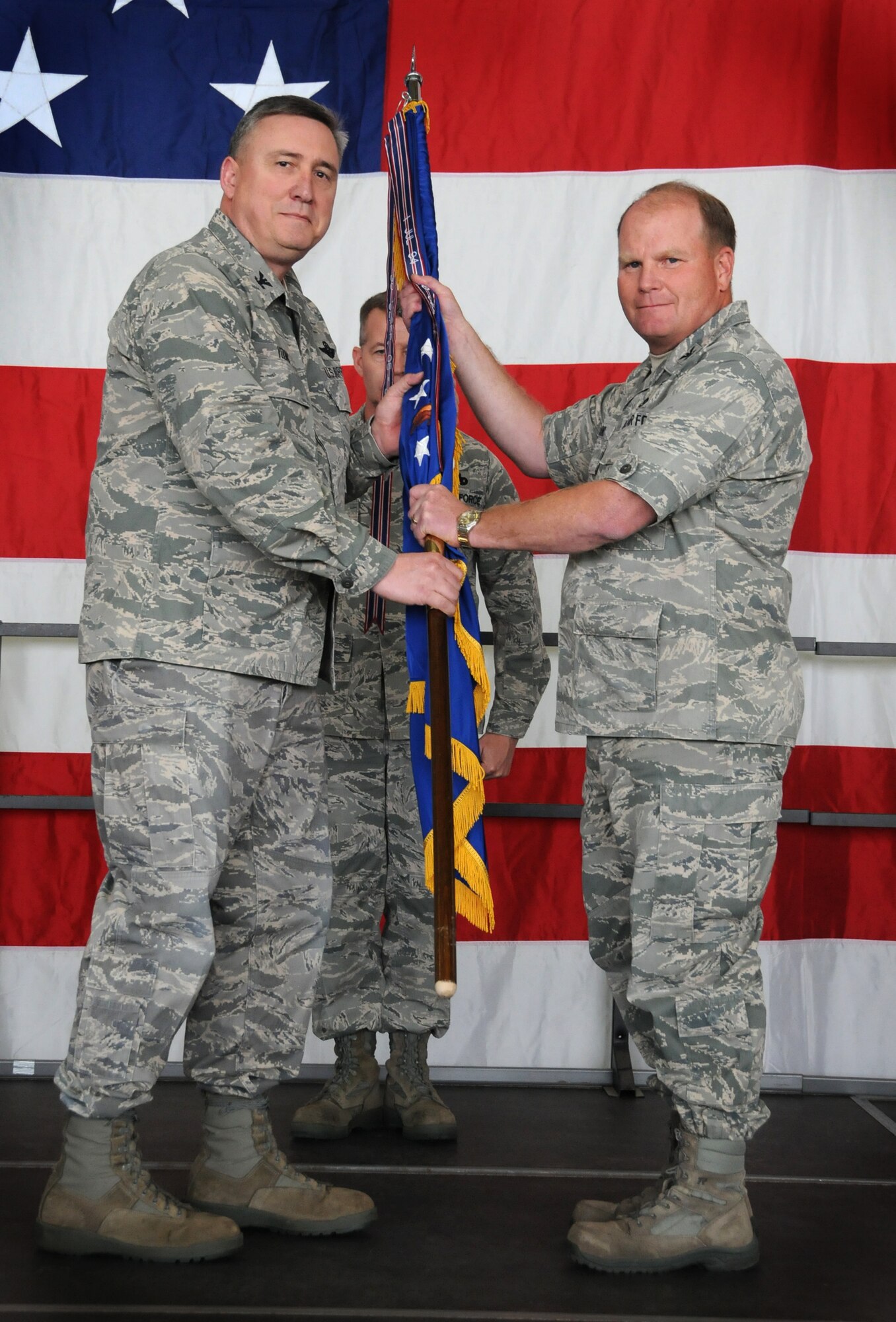 Col. Darrell G. Young, 934th Airlift Wing commander, passes the 934th Maintenance Group guidon to Col. Cam J. LeBlanc as he assumes command of the Group at the Minneapolis-St. Paul Air Reserve Station, Minn.  (U.S. Air Force Photo/Tech Sgt. Bob Sommer)
