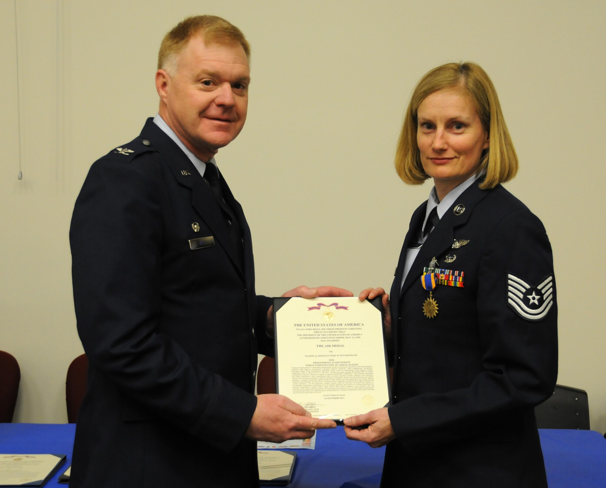 Col. Ronald A. Wilt, 934th Operations Group commander, presents the Air Medal to Tech. Sgt. Mary Wetterstrand of the 934th Aeromedical Evacuation Squadron at the Minneapolis-St. Paul Air Reserve Station, Minn. (U.S. Air Force Photo/Tech. Sgt. Bob Sommer)