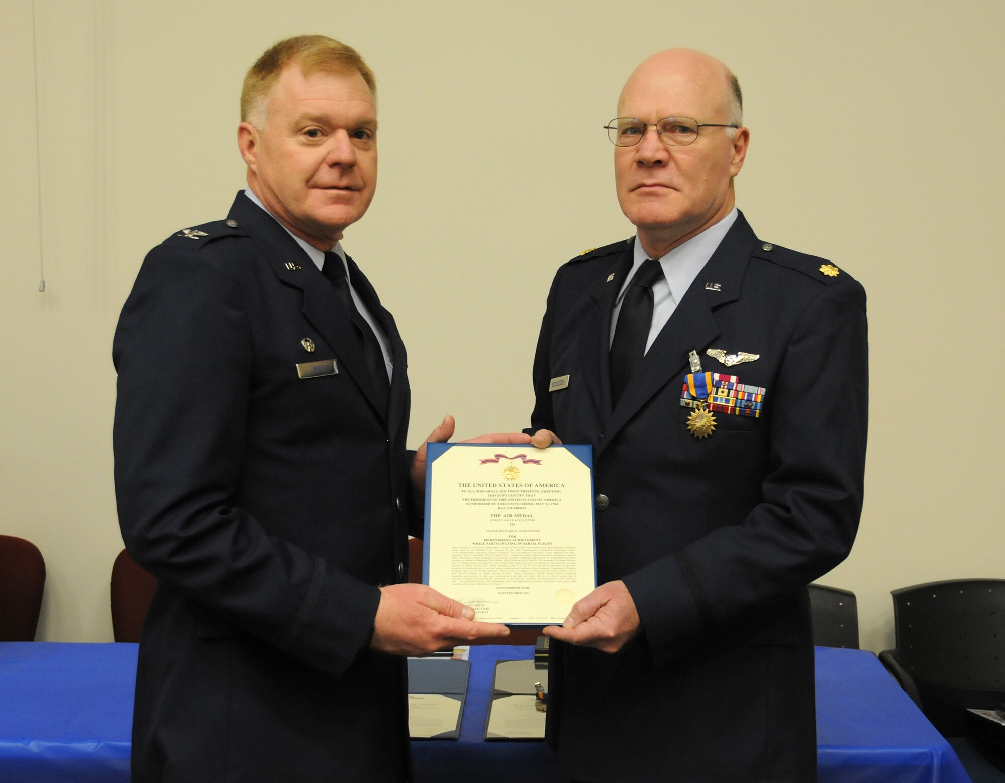 Col. Ronald A. Wilt, 934th Operations Group commander, presents the Air Medal to Maj. Richard Schloesser of the 934th Aeromedical Evacuation Squadron at the Minneapolis-St. Paul Air Reserve Station, Minn. (U.S. Air Force Photo/Tech. Sgt. Bob Sommer)