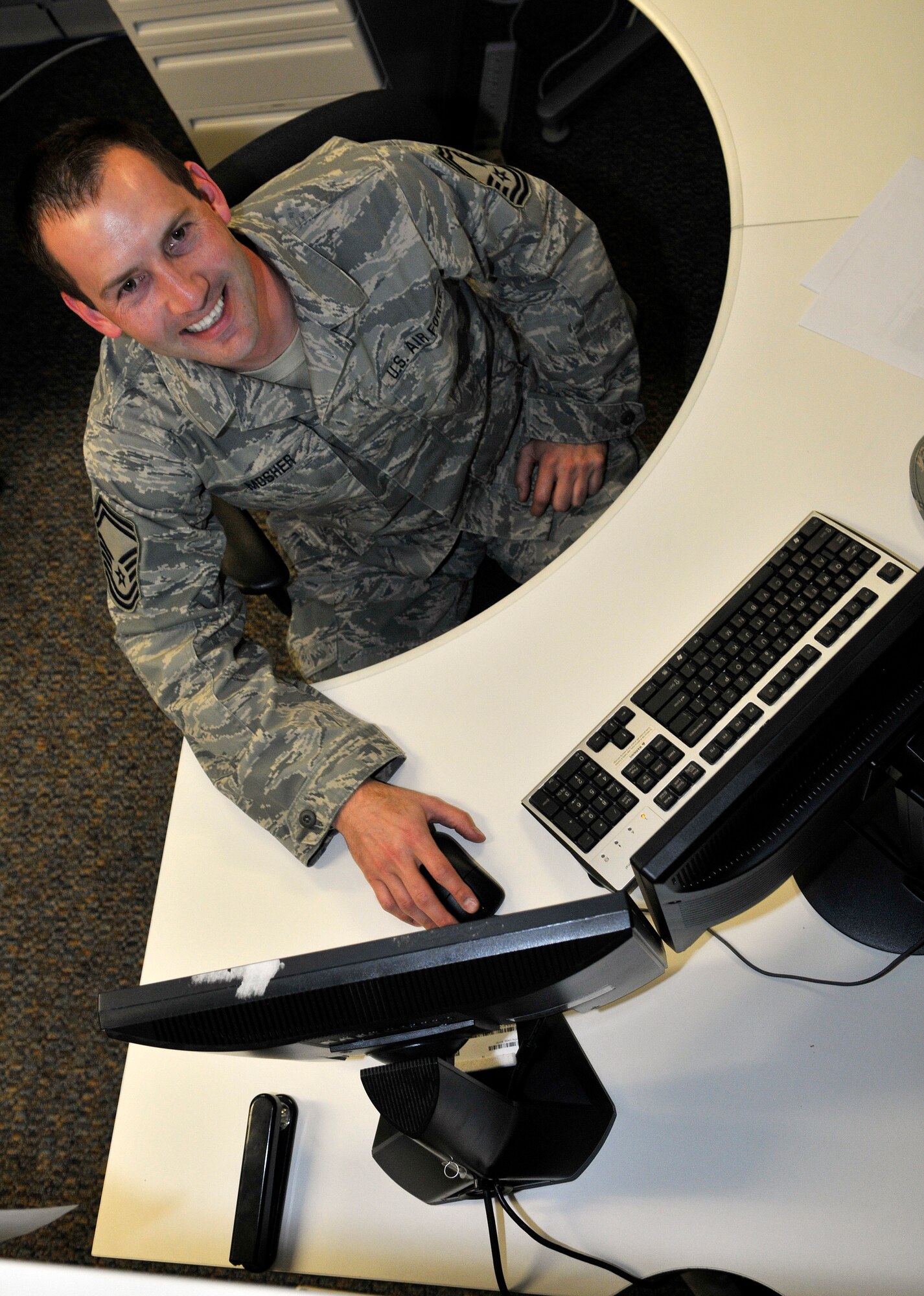 U.S. Air Force Senior Master Sgt. Cody Mosher analyzes client systems for quality assurance from his desk from the Utah Air National Guard Base in Salt Lake City Utah, 3 Mar 2012. (U.S. Air Force Phot by Tech. Sgt. Jeremy Giacoletto-Stegall/Released)