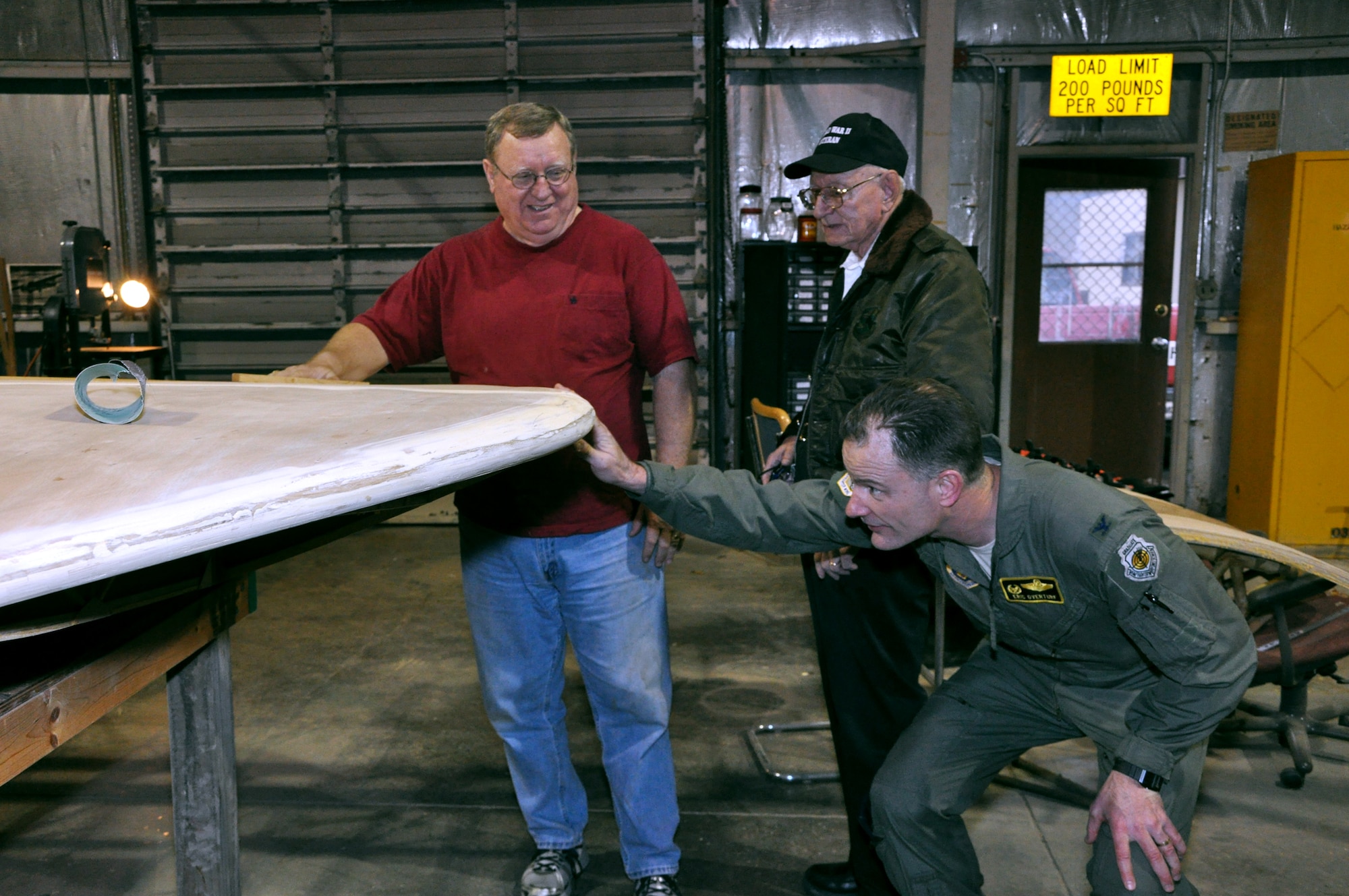 Brig. Gen. (then Col.) Eric Overturf, 442nd Fighter Wing Commander, examines the wing of a CG-4A glider while Frank McKinley and Mel Bockelman look on. at Whiteman Air Force Base, Mo., Feb. 28. The glider is being restored by volunteers.The 442nd Fighter Wing is an A-10 Thunderbolt II Air Force Reserve unit at Whiteman. (U.S. Air Force photo/Senior Airman Wesley Wright)