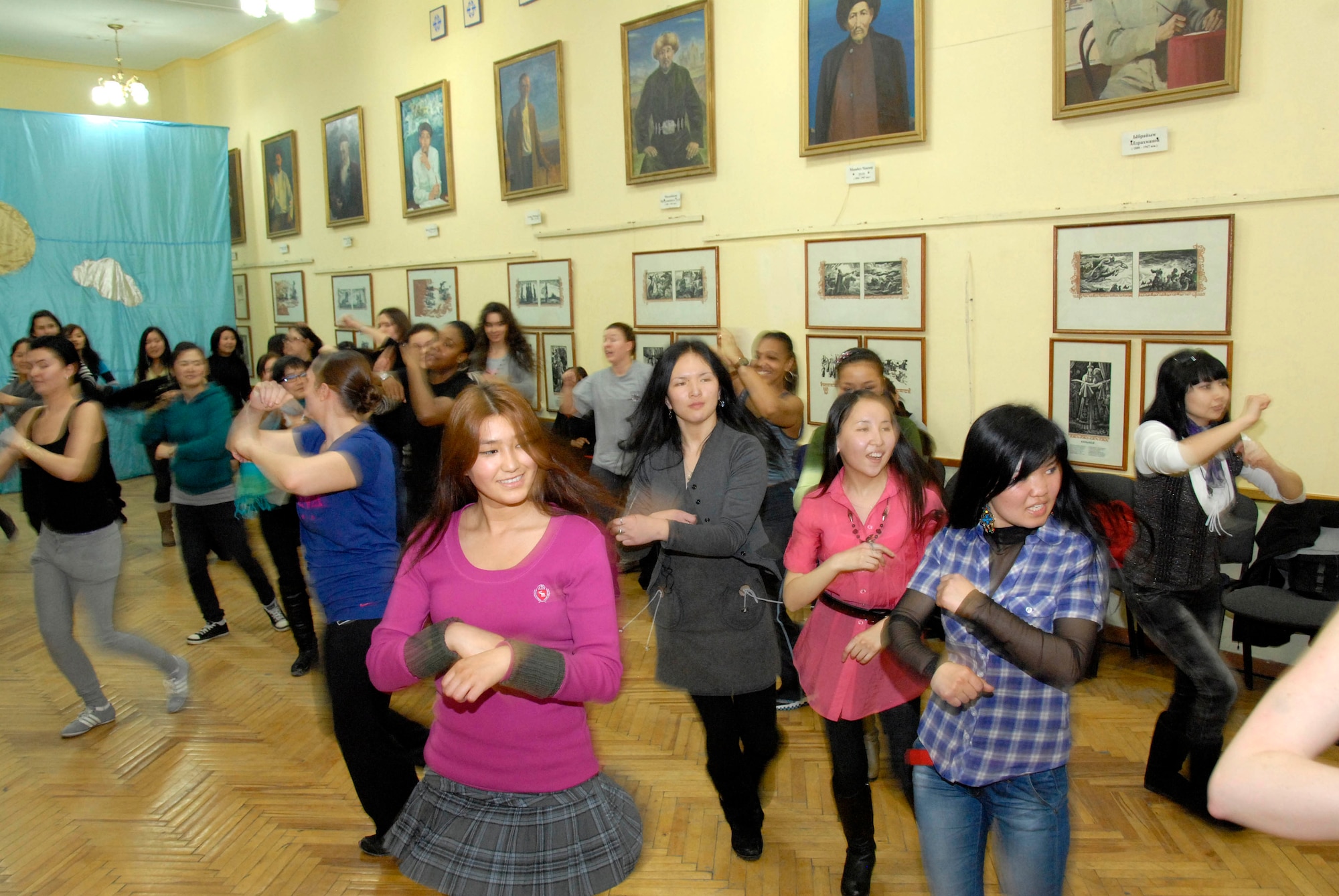 Kyrgyz girls and Transit Center Airmen dance together during a Zumba demonstration at Bayalinov Children's Library in Bishkek March 2, 2012. The group participated together as part of the weekly Women's Club. This week's topic was fitness and exercise. (U.S. Air Force photo/Senior Airman Lynsie Nichols)