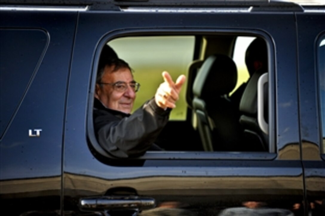 Defense Secretary Leon E. Panetta points toward base commander hosts as he rides in his aircraft after visiting with members of the 101st Airborne Division on Fort Campbell, Ky., March 2, 2012.