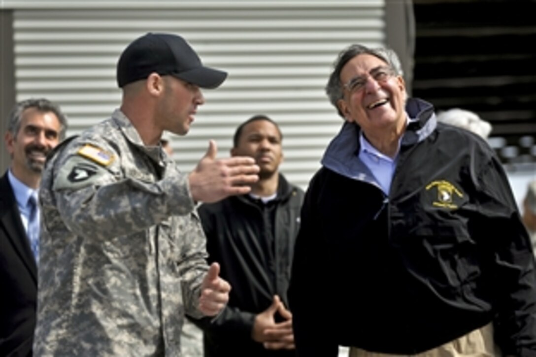 An instructor guides Defense Secretary Leon E. Panetta through a series of rappelling demonstrations during a stop at the Air Assault School on Fort Campbell, Ky., March 2, 2012.