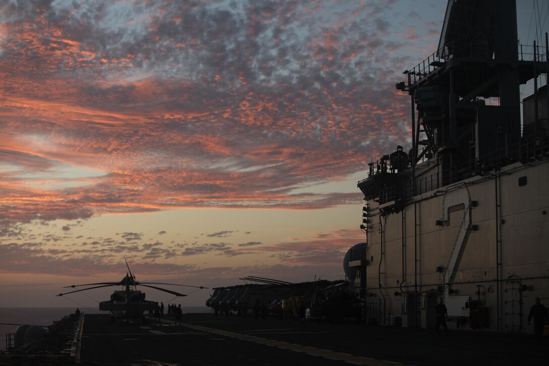 Marines and Sailors of the 31st Marine Expeditionary Unit and Amphibious Squadron 11 watch the sunset aboard the USS Essex (LHD-2) after daily flight operations are completed at sea, March 4. The 31st MEU is conducting amphibious integration training with PHIBRON 11 in preparation for their upcoming Certification Exercise. The 31st MEU is the only continually forward-deployed MEU and is the nation’s force in readiness in the Asia-Pacific region.