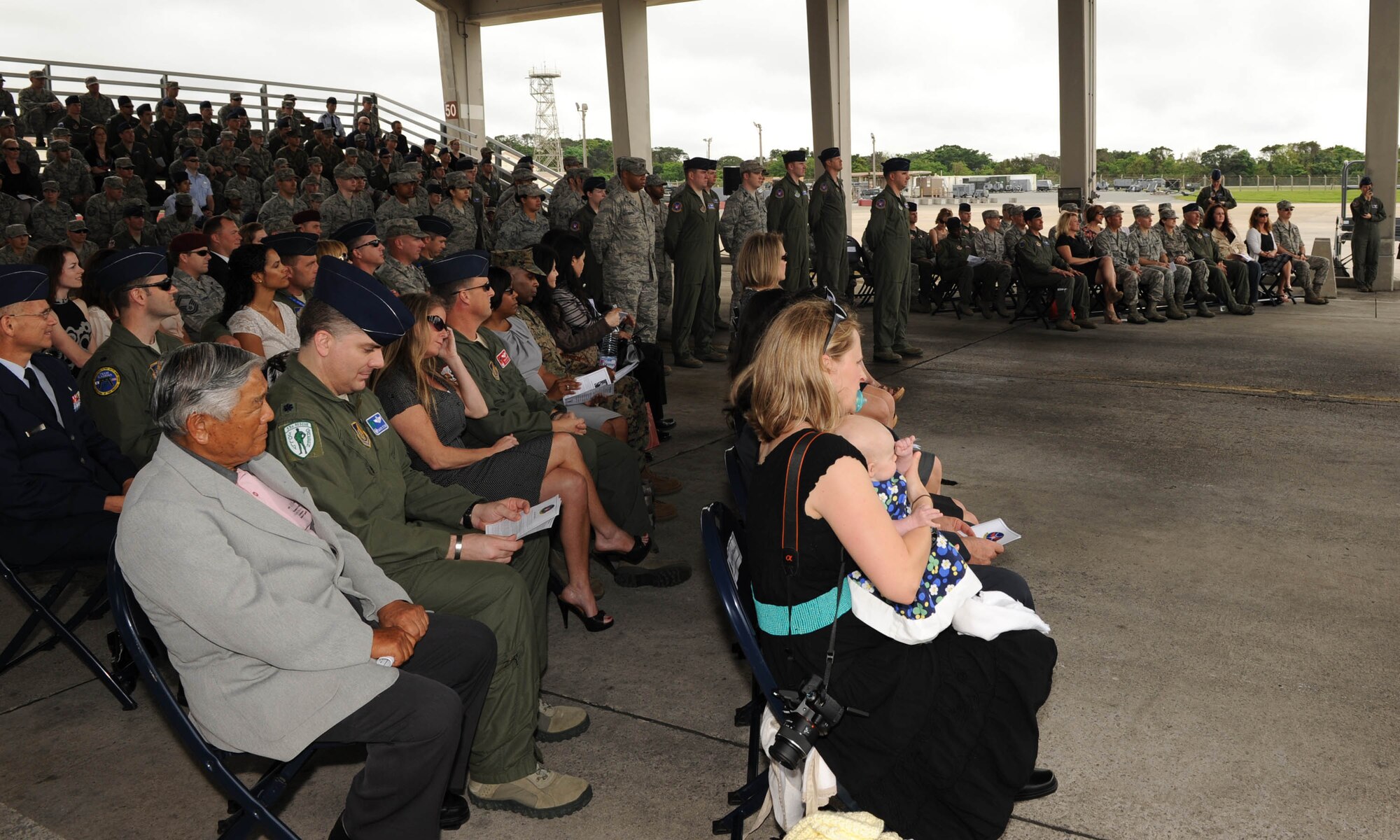 The crowd watches as the 18th Operations Support Squadron proceeds with their change of command ceremony on Kadena Air Base, Japan, March 2, 2012.The present-day ceremony is primarily symbolic; it represents the passing of authority from the outgoing commander to the incoming commander.