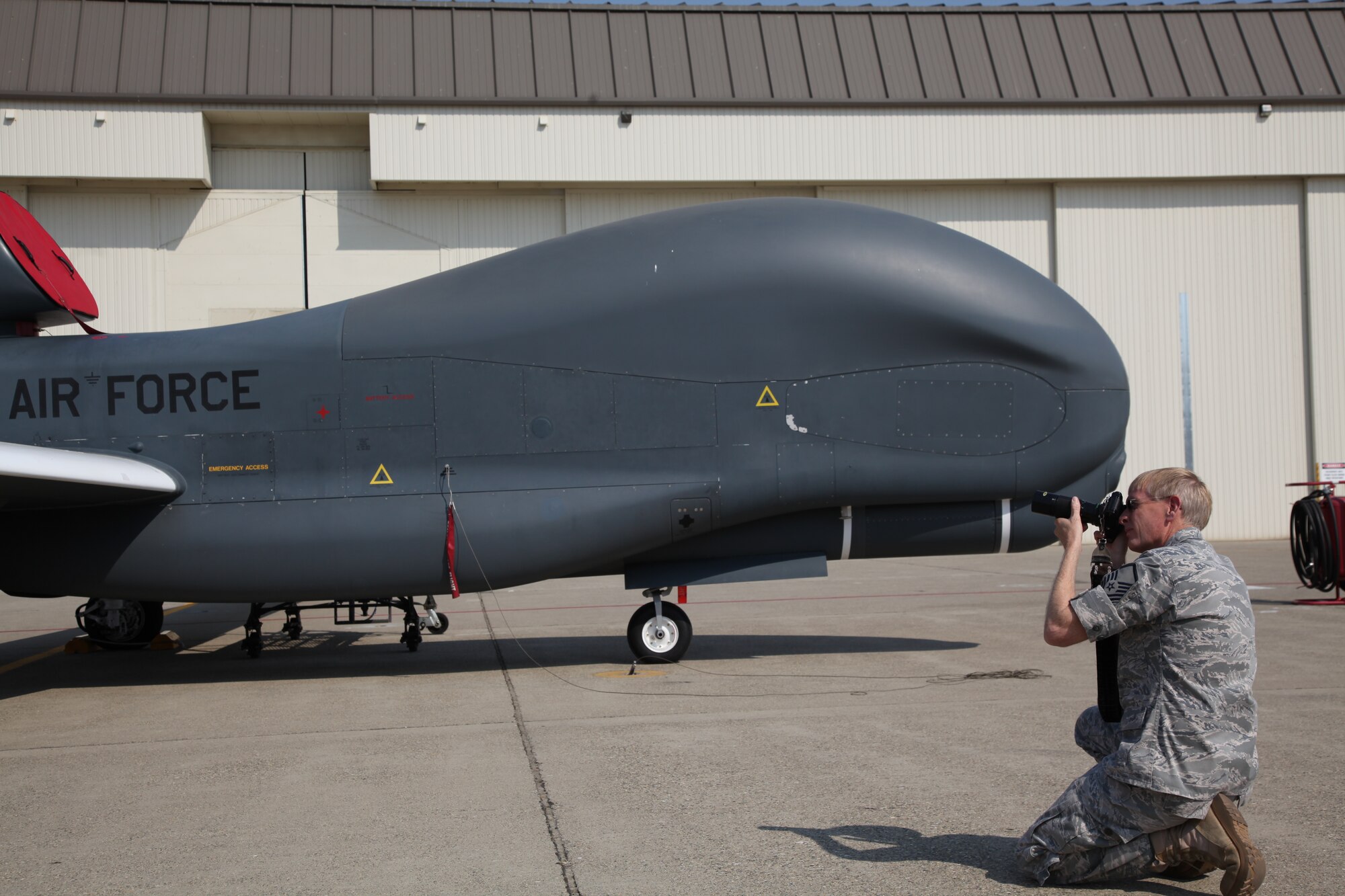 Master Sgt. Douglas Kinsley, 940th Wing Reservist, photographs the RQ-4 Global Hawk during the research phase for a lithograph he will produce for the 13th Reconnaissance Squadron at Beale Air Force Base, Calif. Kinsley's drawings of other military aircraft have been on display in museums across the country, including the Smithsonian Museum in Washington D.C. (U.S. Air Force Photo/Senior Airman Adam Hamar)