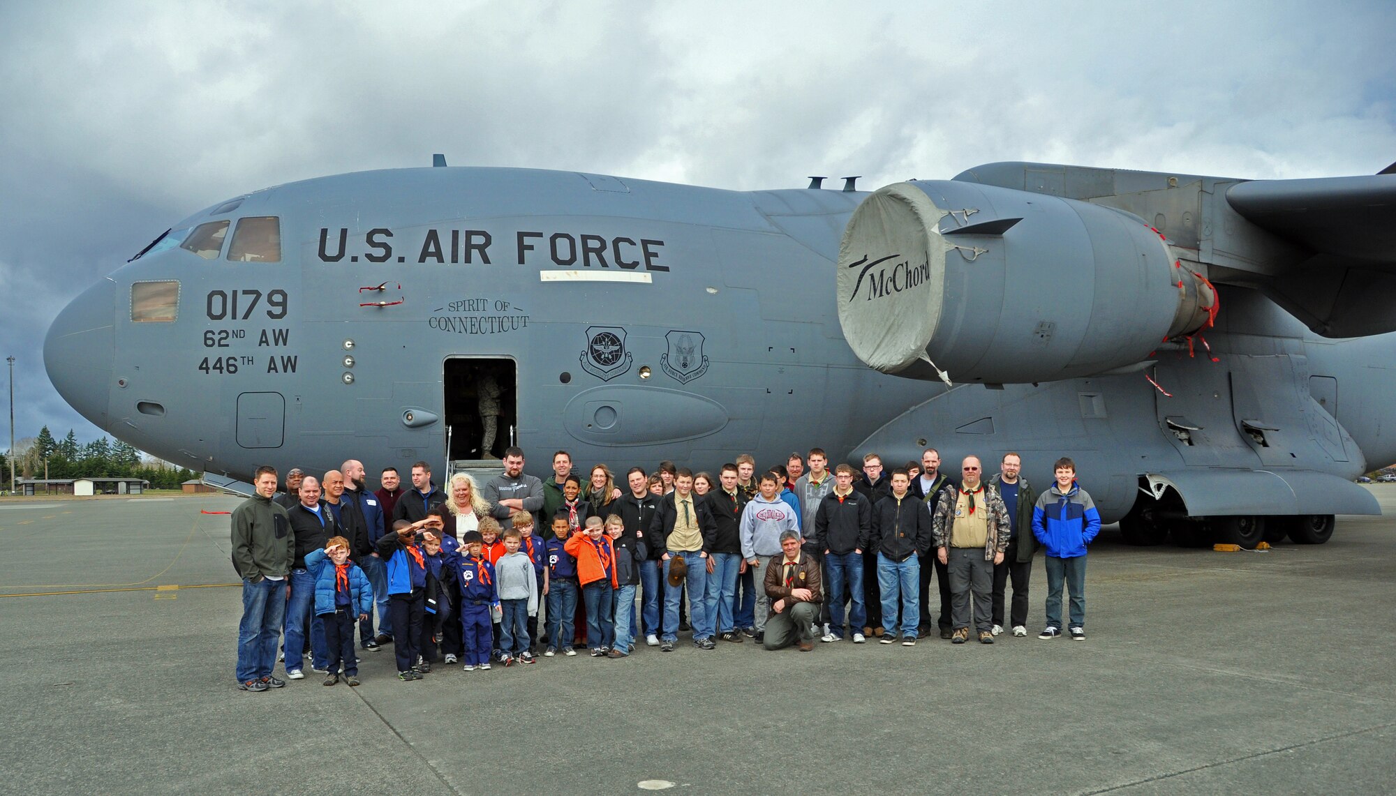 Parents and scouts from Cub Scout Den 3 Pack 391 of Des Moines, Wash., and Boy Scout Troop 43 of Lake Stevens, Wash., pose in front of a C-17 Globemaster III for a group photo March 3 after visiting the 446th Airlift Wing, McChord Field, Wash.  The Scouts and Cubs, in addition to touring the aircraft, they toured the explosive ordinance facility, the air traffice control tower and had a wing mission briefing.  The 446th AW public affairs office hosted the tour as part of its community outreach program.