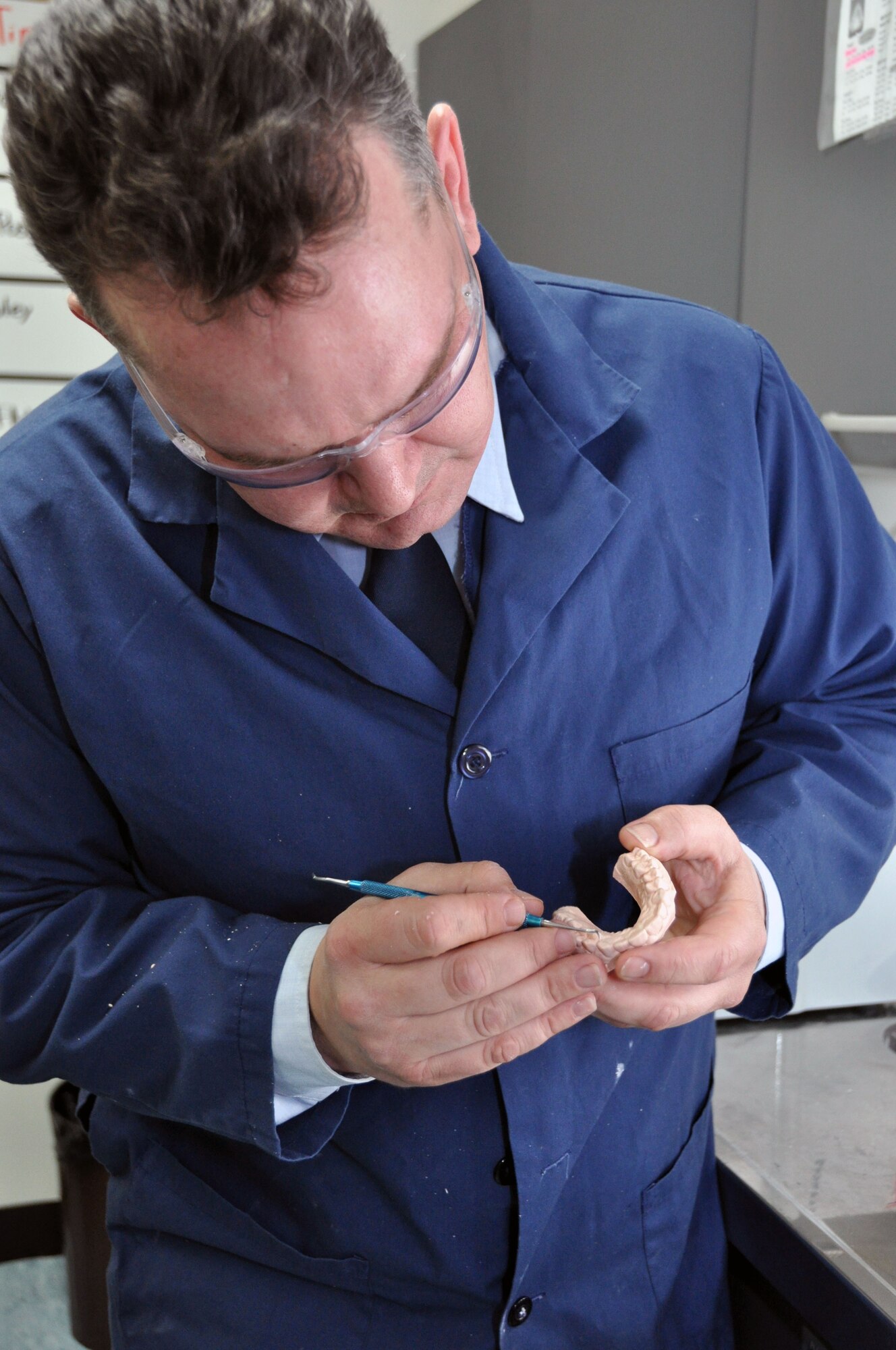 Staff Sgt. John Riaubia, 51st Dental Squadron Dental Lab alternate flight chief, removes residual impression fragments from adental stone at the Osan Air Base Dental Lab Feb, 27, 2012. Technicians also have several advanced courses offered to them were they learn how to create prosthetics not associated with the mouth such as eyes, ears, noses and full skulls. (U.S. Air Force photo/Airman 1st Class Michael Battles)