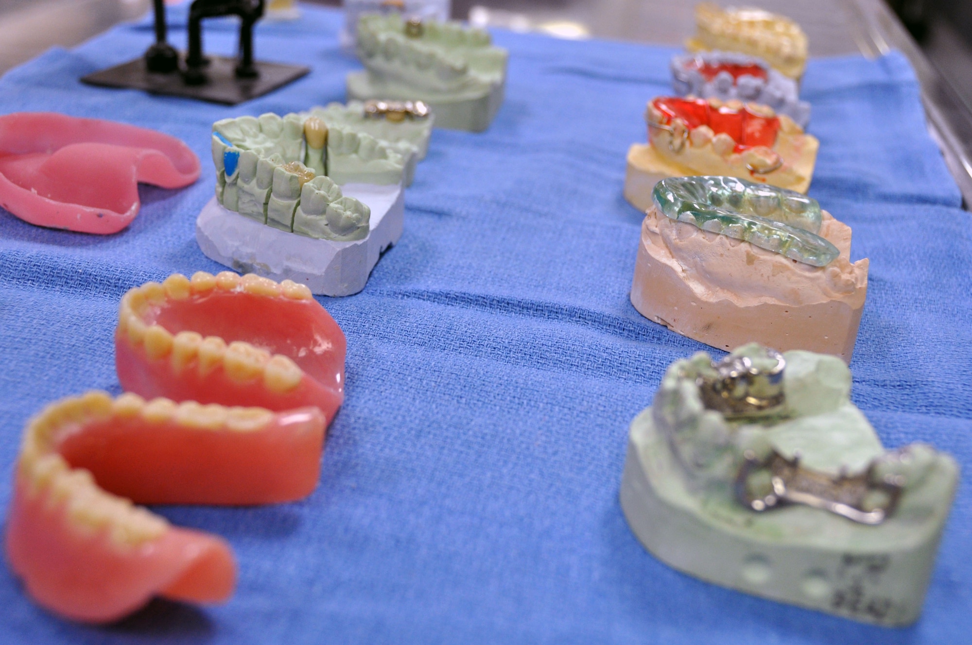 Demonstration models for a variety of dental procedures lay on a work counter at the Osan Air Base Dental Lab Feb, 27, 2012. Technicians also have several advanced courses offered to them where they learn how to create prosthetics not associated with the mouth such as eyes, ears, noses and full skulls. (U.S. Air Force photo/Airman 1st Class Michael Battles))