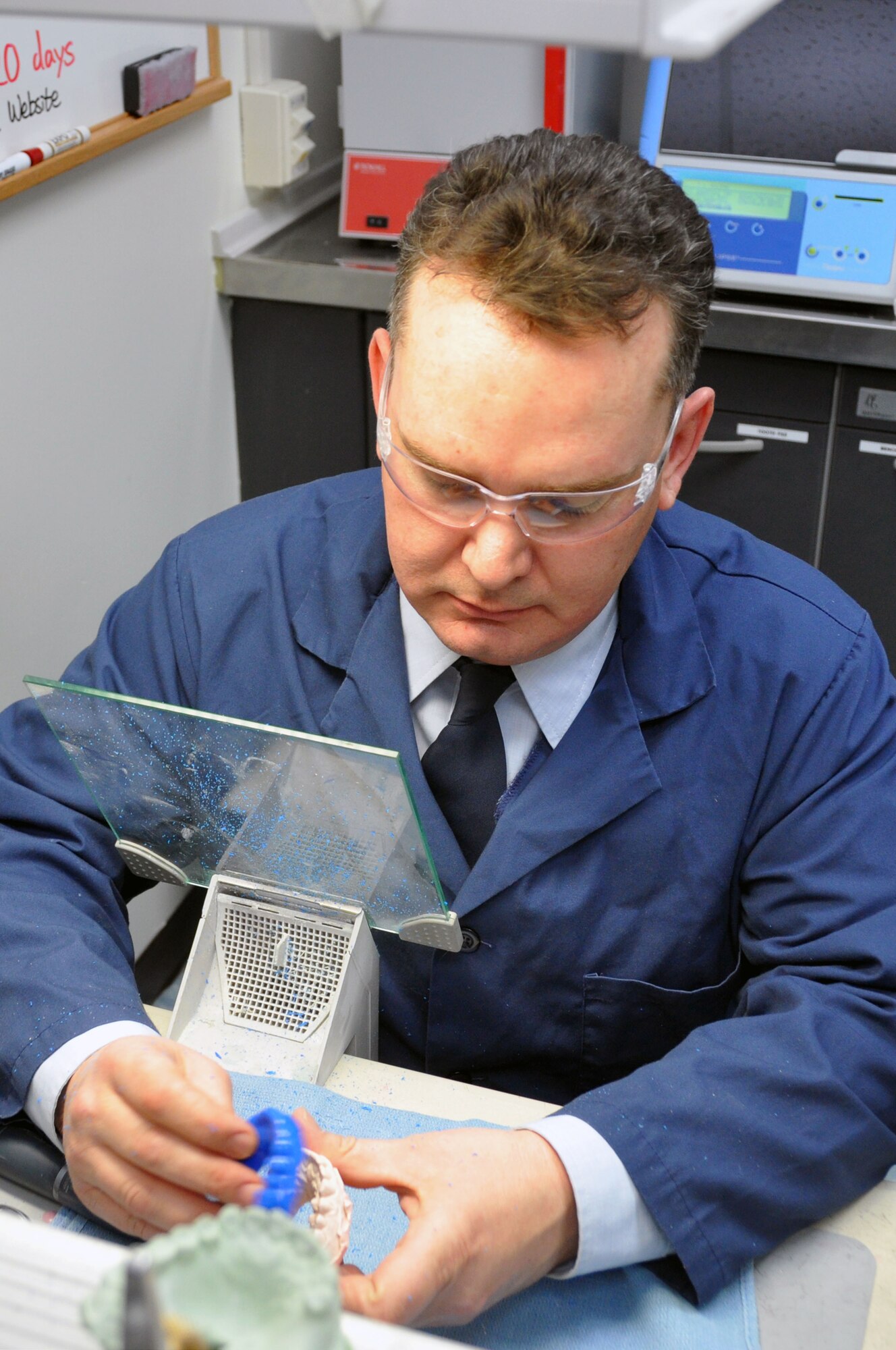 Staff Sgt.  John Riaubia, 51st Dental Squadron Dental Lab alternate flight chief, fits a mouth sports guard to a  mouth impression dental stone at the Osan Air Base Dental Lab Feb, 27, 2012. Technicians also have several advanced courses offered to them where they learn how to create prosthetics not associated with the mouth such as eyes, ears, noses and full skulls. (U.S. Air Force photo/Airman 1st Class Michael Battles)