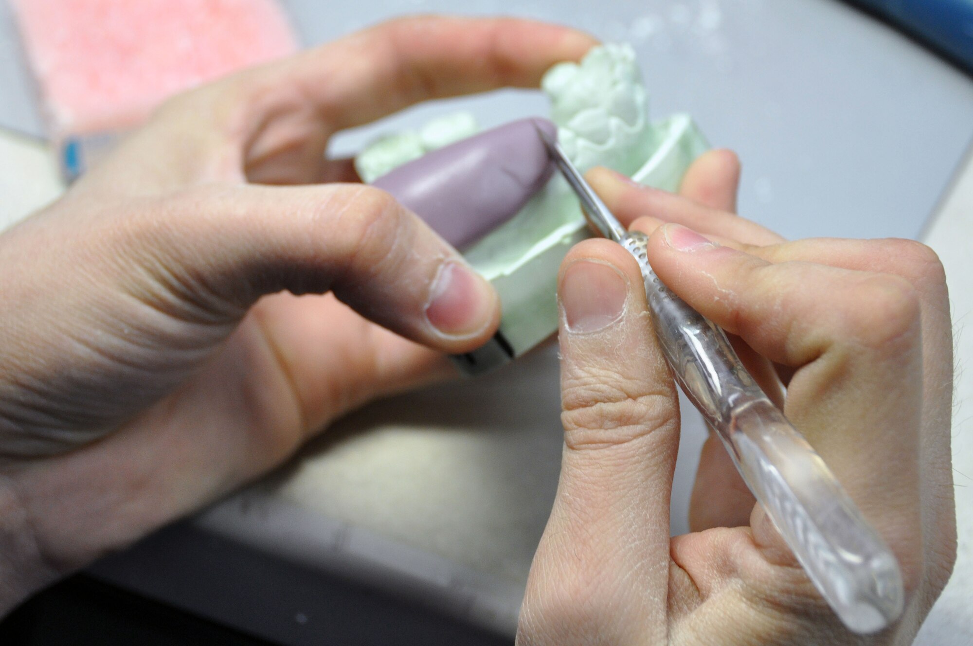 Senior Airman Scott Dallas, 51st Dental Squadron Dental Lab technician, cuts a stent used for a temporary crown at the Osan Air Base Dental Lab Feb, 27, 2012. Technicians also have several advanced courses offered to them were they learn how to create prosthetics not associated with the mouth such as eyes, ears, noses and full skulls.  (U.S. Air Force photo/Airman 1st Class Michael Battles)