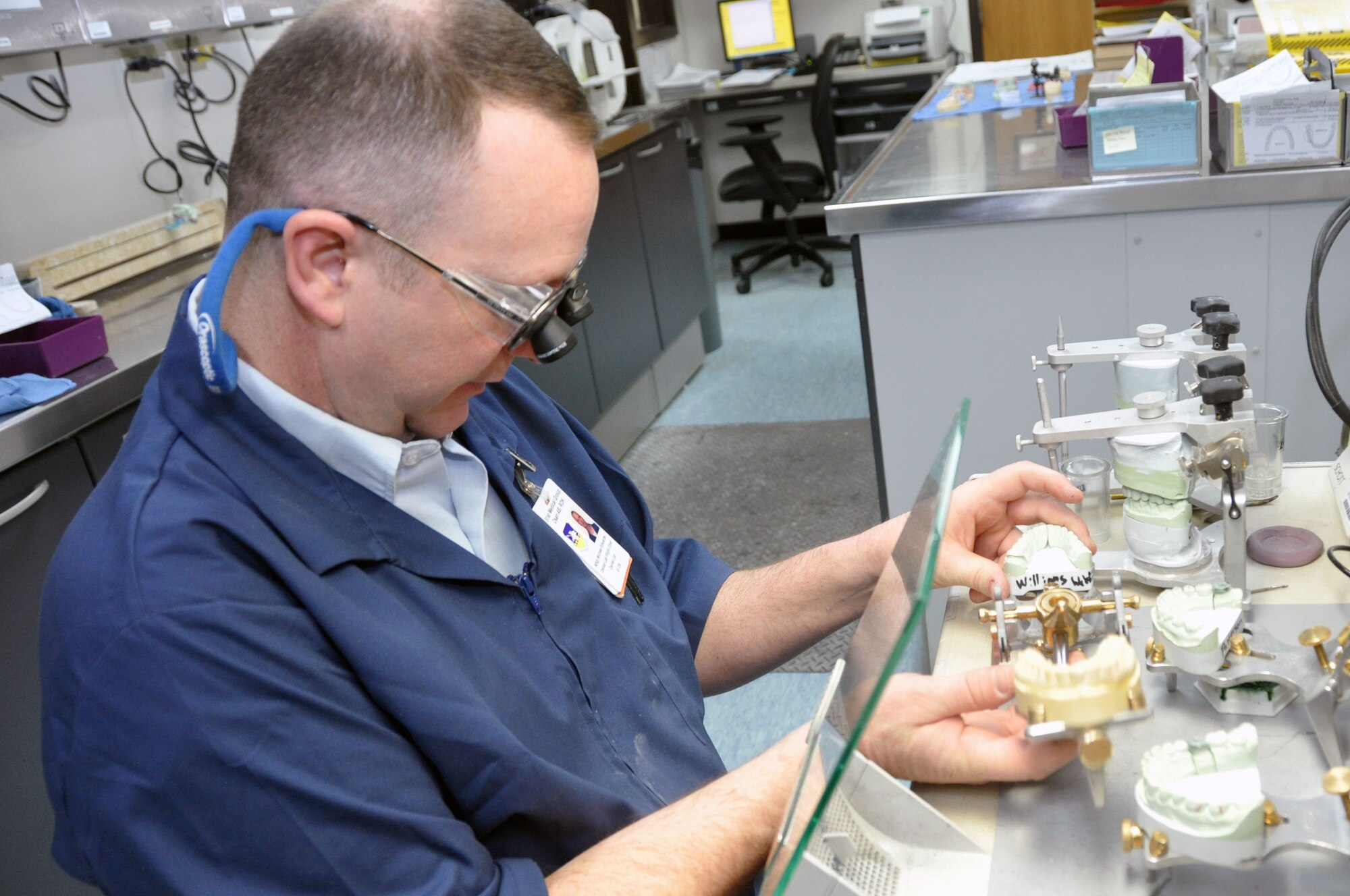 Master Sgt. Michael Edwards, 51st Dental Squadron Dental Lab flight chief, adjusts a porcelain fused piece to a metal crown at the Osan Air Base Dental Lab Feb, 27, 2012. Technicians also have several advanced courses offered to them where they learn how to create prosthetics not associated with the mouth such as eyes, ears, noses and full skulls. (U.S. Air Force photo/Airman 1st Class Michael Battles)
