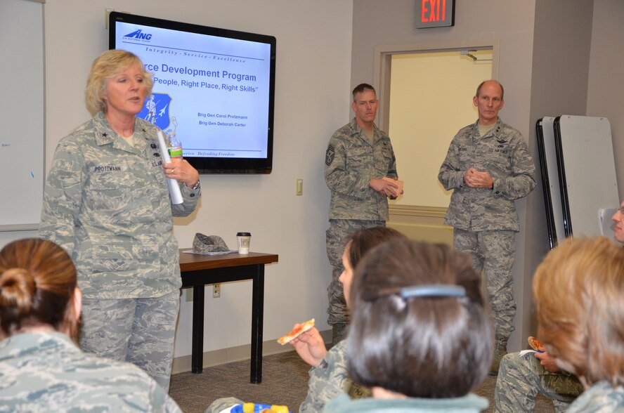 Brig. Gen. Carol Protzmann speaks to a group of company grade officers Jan. 8, 2012 at Pease Air National Guard Base, New Hampshire, to introduce the force development program created by the strategic planning system (SPS).  Major General William N. Reddel III, The Adjutant General, New Hampshire National Guard and State Command Chief Master Sgt. Matthew J. Collier listen in the background.  (National Guard photo by Tech. Sgt. Angela Stebbins/Released)