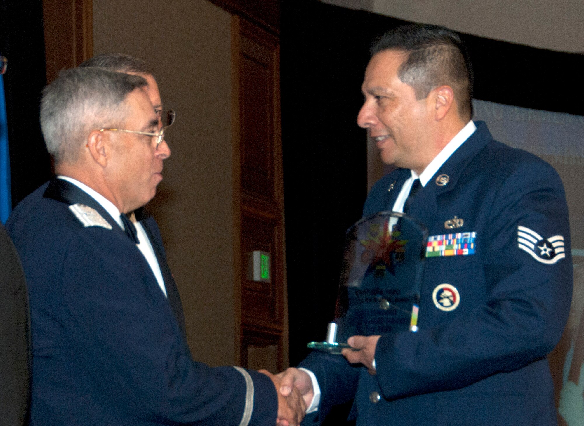 Honor Guard Member Staff Sgt. Jose Toro, assigned to the 162nd Fighter Wing, accepts words of congratulations for his award from Brig. Gen. Michael Colangelo, Arizona Air National Guard commander. (U.S. Air Force photo/Master Sgt. Dave Neve)