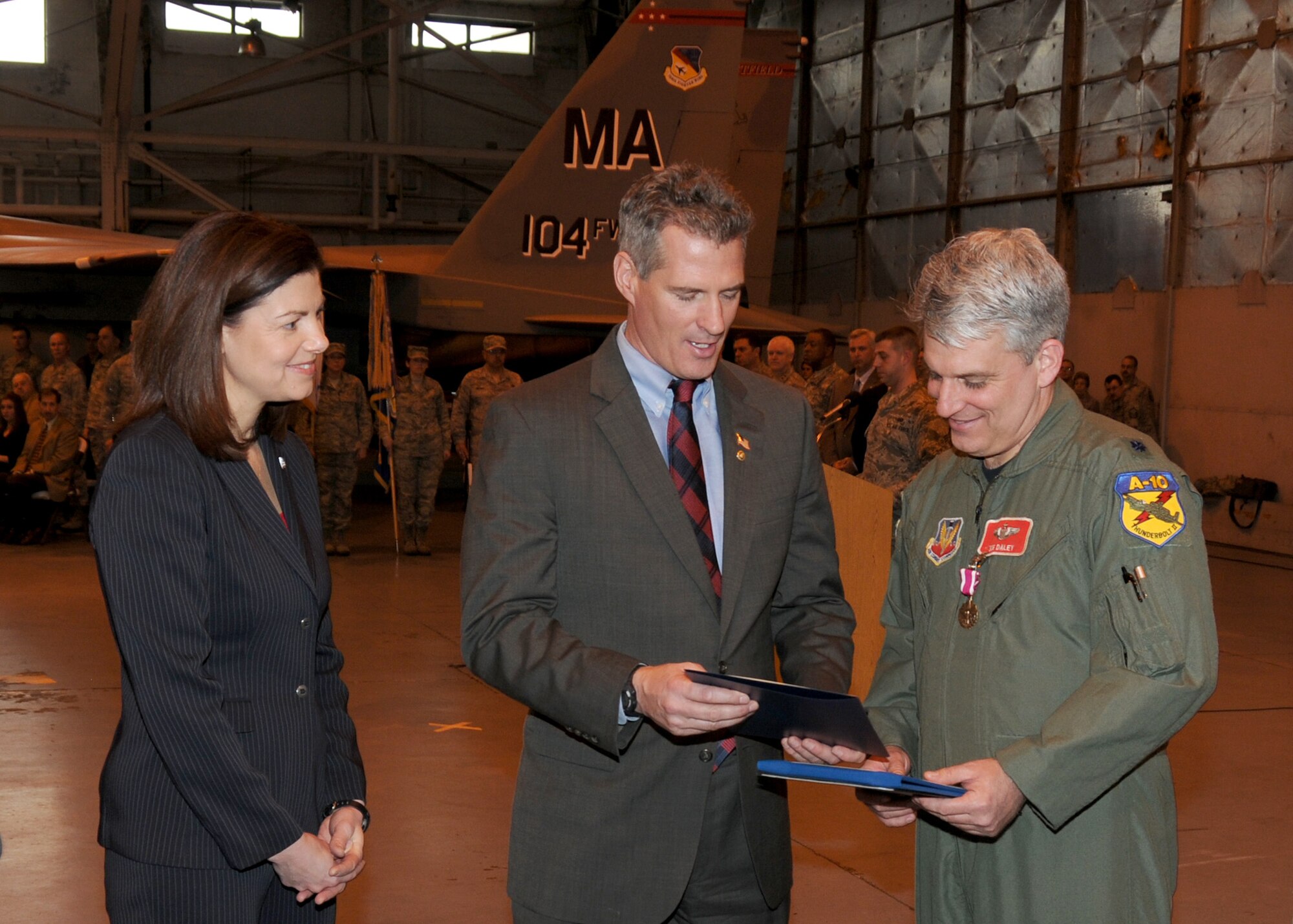 On March 3rd, 2012 Lieutenant Colonel Joseph Daley receives a Meritorious Service Medal and a Retirement certificate from Senator Scott Brown and his wife Senator Kelly Ayotte during a Commanders Call that was held in the main hanger at the 104th Fighter Wing Barnes Air National Guard Base, Westfield, MA. Lieutenant Daley completed 22 years of service.  (Air National Guard photo by Technical Sergeant Melanie J. Casineau)