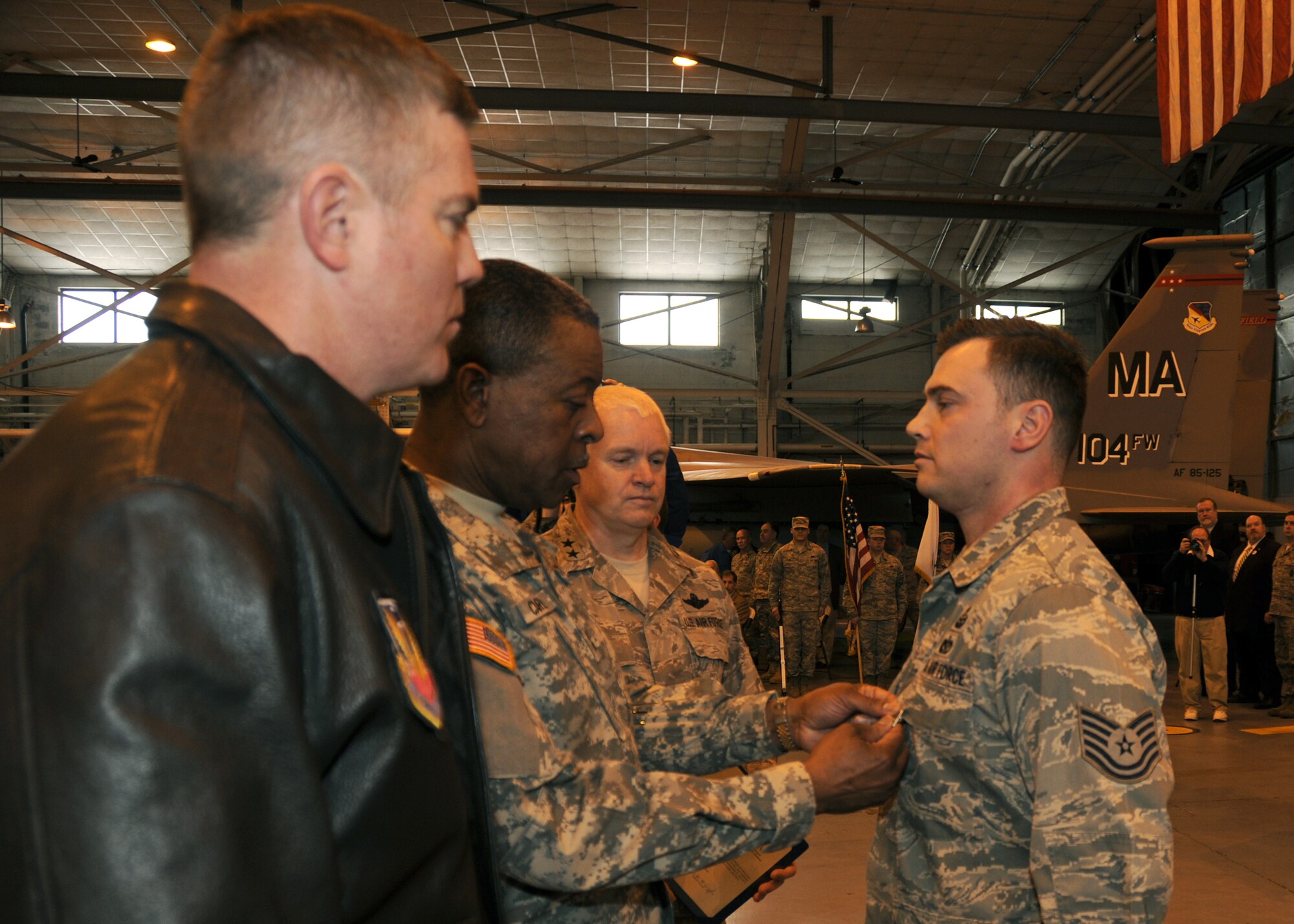 On March 3rd, 2012 Major General Joseph Carter presents a Bronze Star to Staff Sergeant Robert Eisner during a Commander’s Call that was held in the main hanger at the 104th Fighter Wing Barnes Air National Guard Base, Westfield, MA. Staff Sergeant Eisner was awarded the Bronze star for his recent duties overseas. (Air National Guard photo by Master Sergeant Mark Fortin)