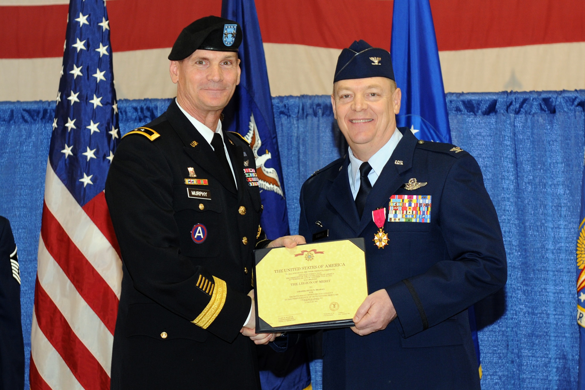Maj. Gen. Patrick Murphy (left), the Adjutant General of the State of New York, presents Col. Kevin Bradley, outgoing 174th Fighter Wing Commander, with the Legion of Merit medal for outstanding leadership.  Col Bradley relinquished command of the 174th Fighter Wing to Col. Greg Semmel during a cermenony held at Hancock Field Air National Guard Base on Sunday March 4, 2012. (New York Air National Guard photo by Staff Sgt. James N. Faso II/Released)
