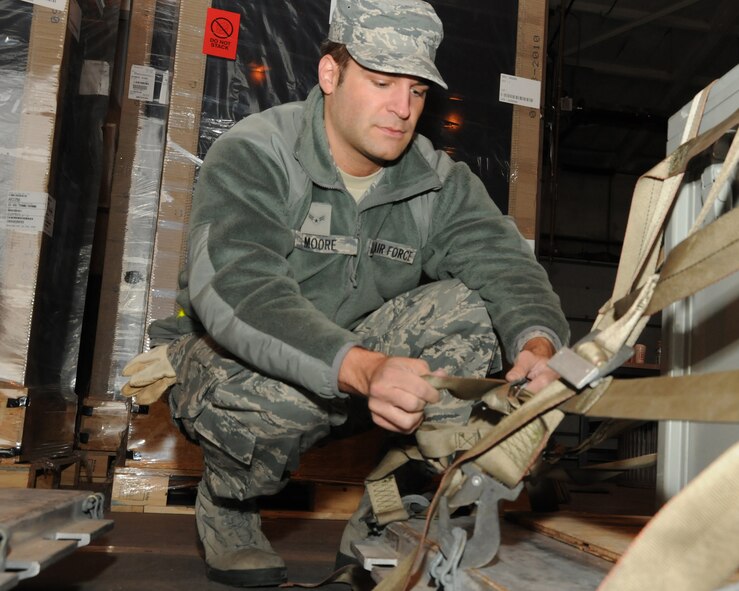 Airman 1st Class Thomas J. Moore secures a cargo palette during a training exercise, Pease Air National Guard Base, N.H., March 4, 2012.  (National Guard photo by Staff. Sgt. Curtis J. Lenz/RELEASED)