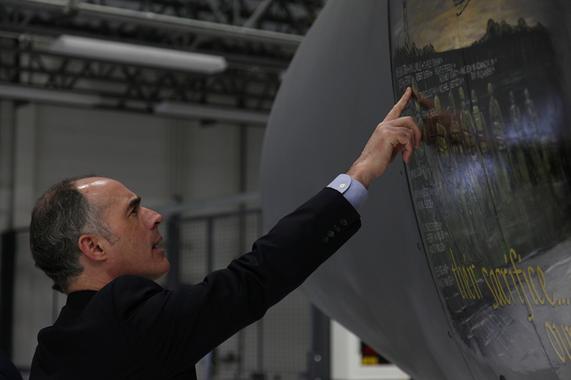U.S. Sen. Robert Casey Jr., D-Scranton, admires hand painted nose art of the Vietnam War Memorial on a C-130H2 aircraft while visiting the 911th Airlift Wing on March 2, 2012. His visit included a walkthrough of the aircraft, a windshield tour of the base and a mission brief. He was escorted by 911th wing leadership in addition to Col. Anthony J. Carrelli, commander, 171st Air Refueling Wing and Cmdr. Tim Flecker, commander, Navy Operational Support Center Pittsburgh. Senator Casey requested the meeting with local military leaders as a result of the Air Force’s recent Force Structure announcement and the Navy’s intent to build their reserve center at the Pittsburgh International Airport Air Reserve Station. (U.S. Air Force photo/Tech. Sgt. Ralph Van Houtem/Released)