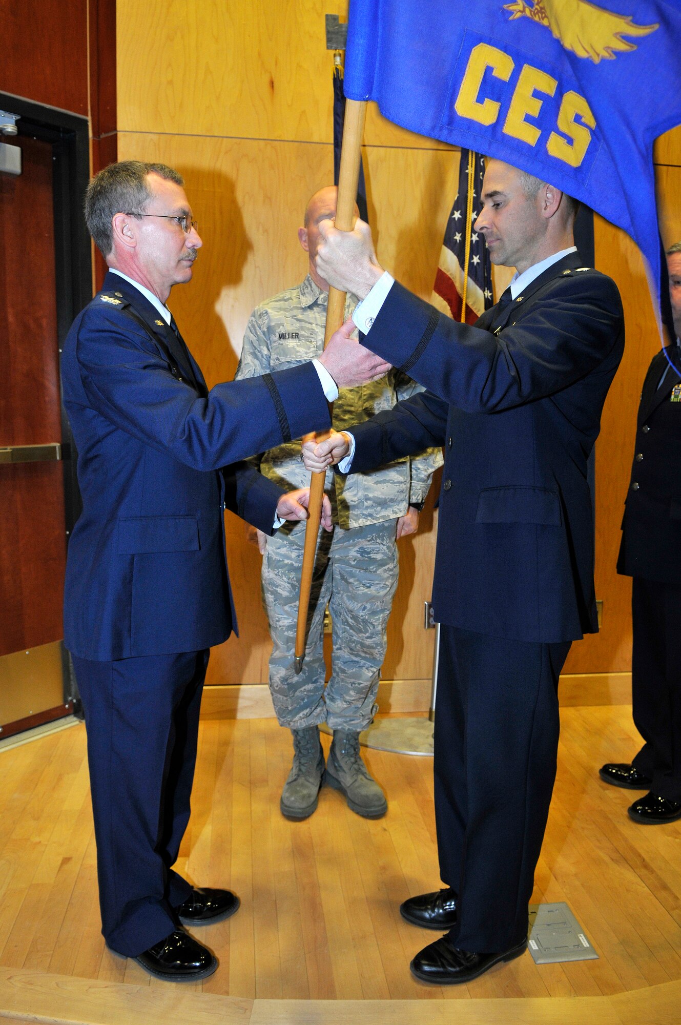 Col. Jack Wall, 151st Mission Support Group commander, accepts the 151st Civil Engineering Squadron guidon from Lt. Col. Anthony Faaborg as he relinquishes command of the 151st CES during the change of command ceremony at the Utah Air National Guard Base in Salt lake City, Utah, March 3. (U.S. Air Force Photo by Tech. Sgt. Jeremy Giacoletto-Stegall/Released)