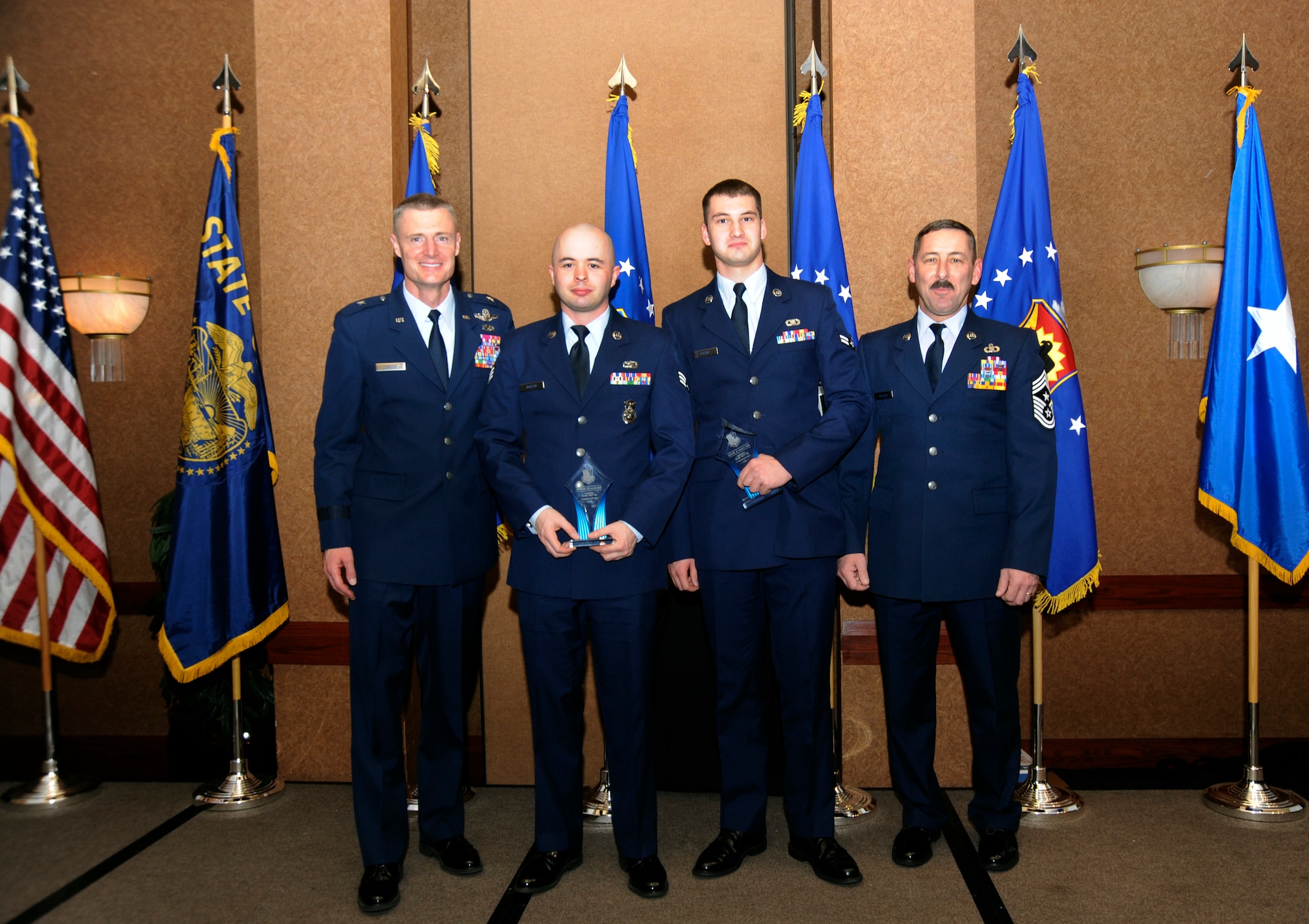 Oregon Air National Guard Commander Brig. General Steven Gregg stands (left to right) with Category I level award winners, Senior Airman Issac K. Martin and Airman First Class Craig Payne, along with Oregon State Command Chief Master Sgt. Mark Russell during the 18th Annual Oregon Air National Guard Awards Banquet, held in Portland, Ore., on February 25, 2012. (US Air Force Photograph by Tech. Sgt. John Hughel, 142nd Fighter Wing Public Affairs)(Released)