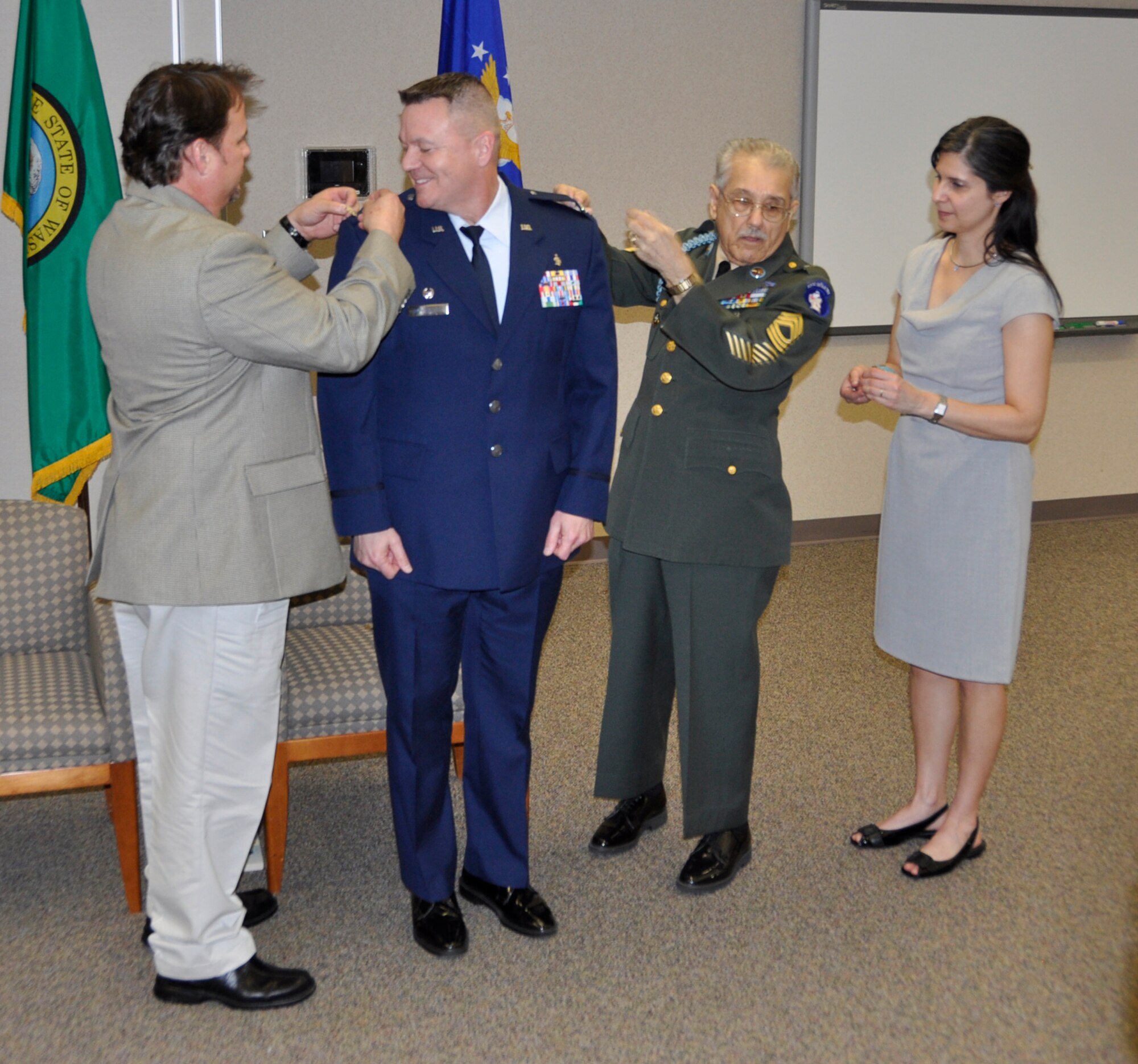 Family members of Col. Rob Richardson, 446th Aeromedical Staging Squadron Commander, pin on the colonel's eagles during the March 3 promotion ceremony on McChord Field. Col. Richardson enlisted in 1982. He says it's been "a long road from airman basic." (U.S. Air Force photo/Staff Sgt. Rachael Garneau)
