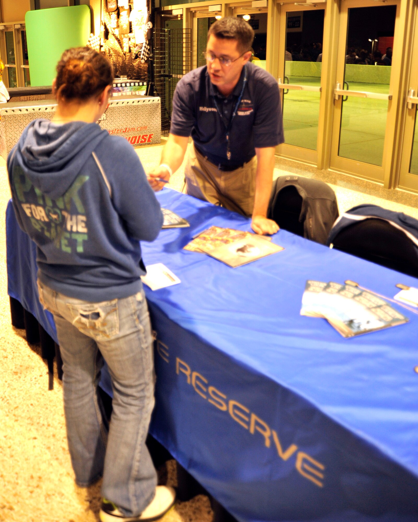 Tech. Sgt. Pete Wypyszinski provides informaton about the U.S. Air Force Reserve to a potential recruit during Monster Jam 2012 held at the Gulf Coast Coliseum Mar. 2-3. The 403rd Wing recruiters were at Monster Jam 2012 to recruit leads for the U.S. Air Force Reserve. Monster Jam was sponsored by a number of companies, to include the U.S. Air Force Reserve. The two-day event entertained crowds with monster truck action and paid tribute to the U.S. military, police officers and firefighters. (U.S. Air Force photo by Maj. Heather Newcomb)
