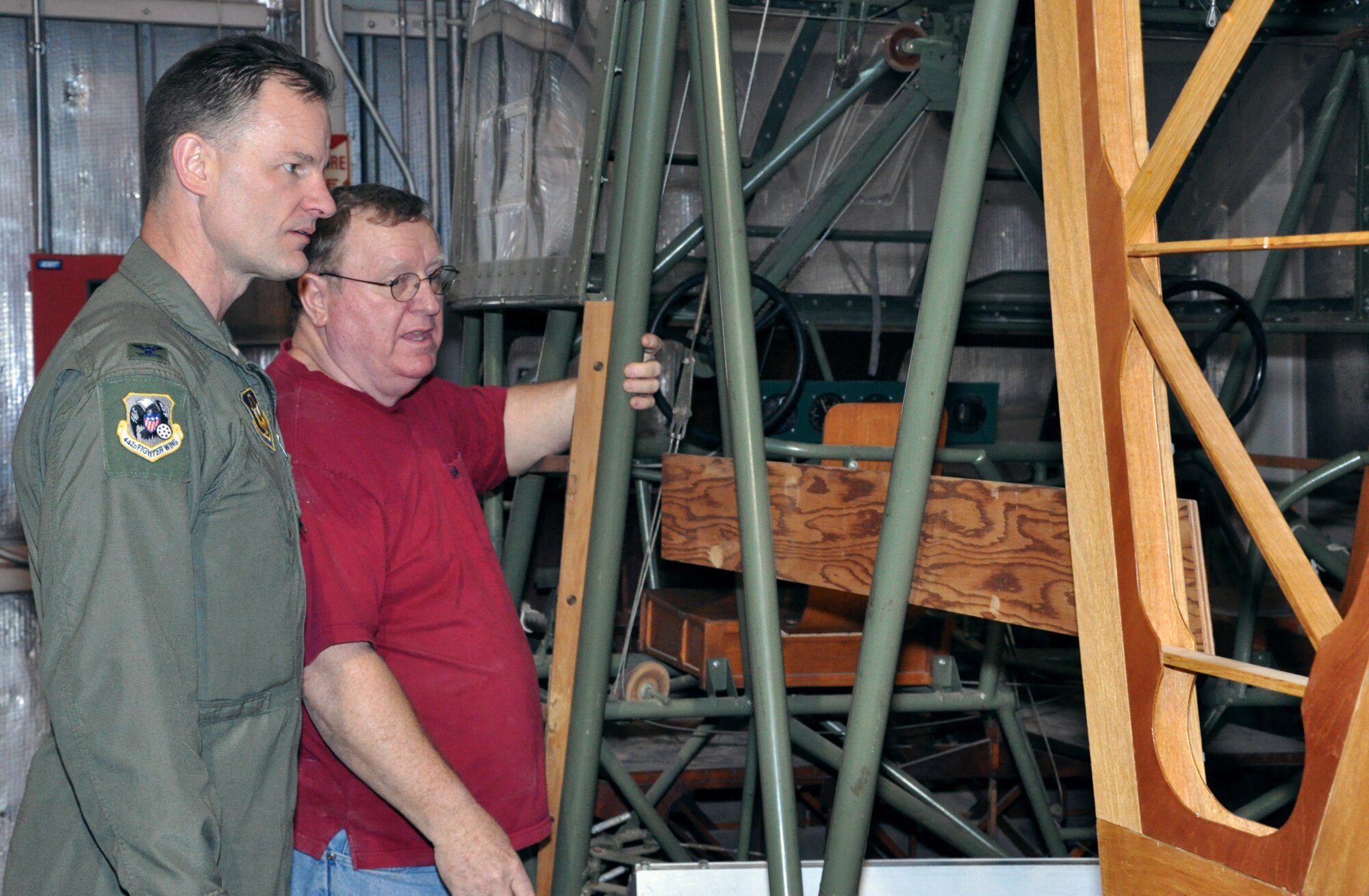 Brig. Gen. (then Col.) Eric Overturf, 442nd Fighter Wing Commander, examines the emergency exit on a CG-4A glider while Frank McKinley looks on, at Whiteman Air Force Base, Mo., Feb. 28. The glider is being restored by volunteers.The 442nd Fighter Wing is an A-10 Thunderbolt II Air Force Reserve unit at Whiteman. (U.S. Air Force photo/Senior Airman Wesley Wright)