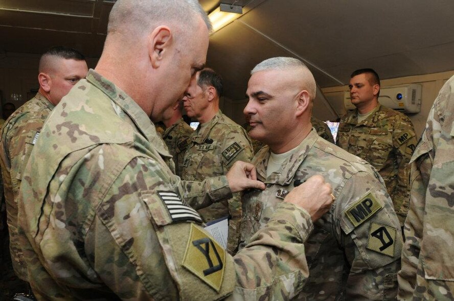 Brig. Gen. John Hammond, 26th Maneuver Enhanced Brigade commander, pins on the Combat Action Badge onto Senior Master Sgt. Emilio Rodriguez, 161st Security Forces Squadron, in Afghanistan. Sergeant Rodriguez deployed as the Provost Marshall Sergeant Major for the Kabul Capital Base Cluster from August through December 2011. Sergeant Rodriguez received the Army’s Combat Action Badge for being engaged by small arms fire during a convoy escort operation. The Combat Action Badge was approved by the Army chief of Staff in 2005 to provide special recognition to Soldiers who personally engage or are engaged by the enemy. (Courtesy photo) 