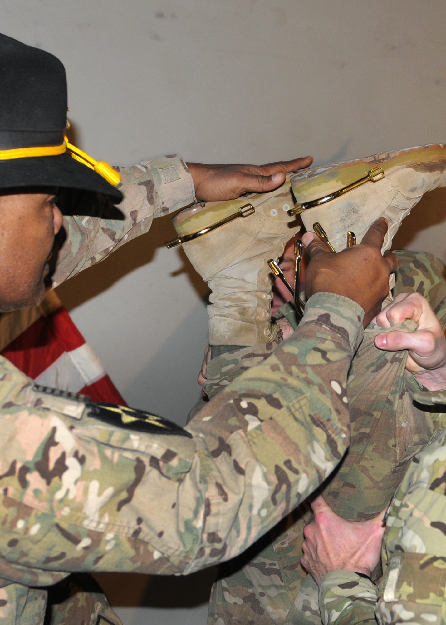 Golden spurs are applied to the boots of competitors who complete the challenges at the Spur Ride at Bagram Airfield, Afghanistan, Feb. 21, 2012.  The Spur Ride is a series of mental and physical tests that evaluated leadership, technical and tactical proficiency, and the ability to operate as part of a team under high levels of stress and fatigue, under both day and night conditions.  Spur Holders are then inducted into the Order of the Spur.  (U.S. Army photo/Sgt. Andrea Merritt)