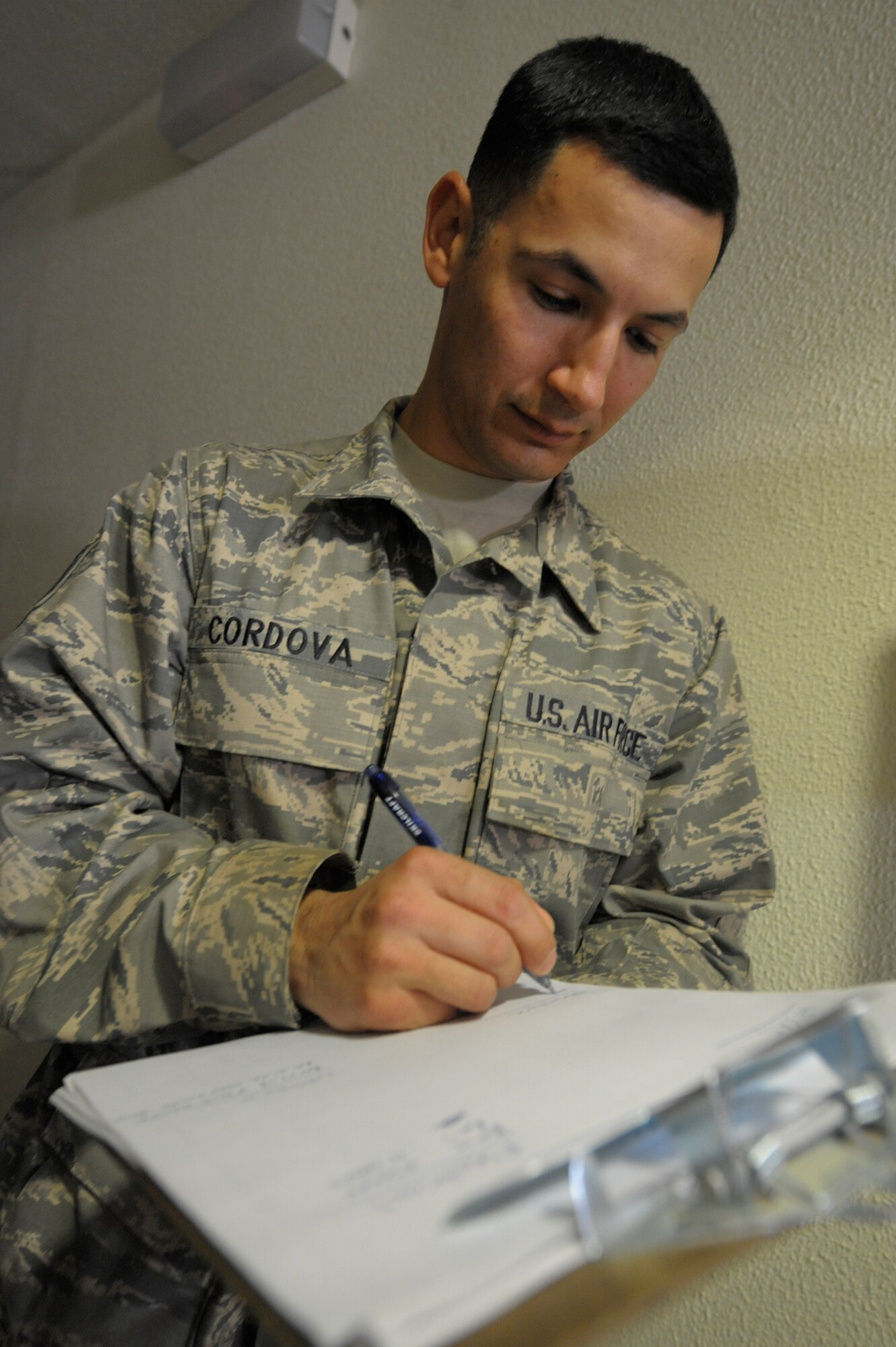 Tech. Sgt. Robert Cordova, 332nd Expeditionary Civil Engineer Squadron electrician, documents building discrepancies to a dorm at an undisclosed location in Southwest Asia, Mar. 3, 2012. Cordova was part of an eight-man team who inspected dorms for any electrical, plumbing, structural, and cooling or heating issues.  Cordova is deployed from Dyess Air Force Base, Texas, and is a native of San Jose, Calif. (U.S. Air Force photo by Staff Sgt. Joshua J. Garcia/Released)