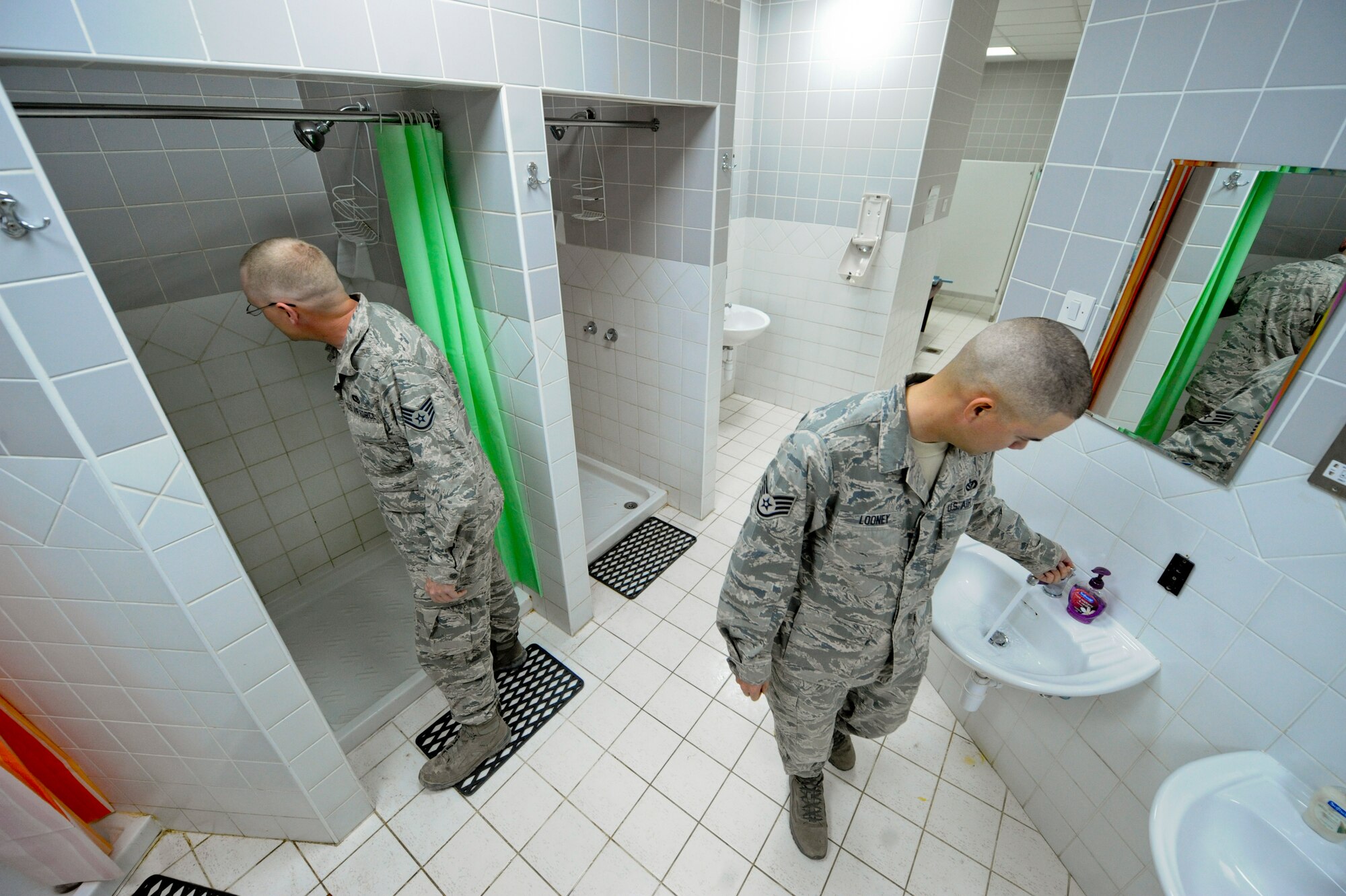 Staff Sgt. Christopher Dunaway (Left), and Staff Sgt. Christopher Looney, 332nd Expeditionary Civil Engineer Squadron utilities flight members, check a dormitory bathroom at an undisclosed location in Southwest Asia, March 3, 2012. Dunaway and Looney checked for leaks and ensured the plumbing worked properly. Dunaway is deployed from Peterson Air Force Base, Colo., and is a native of Nashville, Tenn. Looney is deployed from Mountain Home Air Force Base, Idaho, and is a native of Duncan, Okla. (U.S. Air Force photo by Staff Sgt. Joshua J. Garcia/Released)