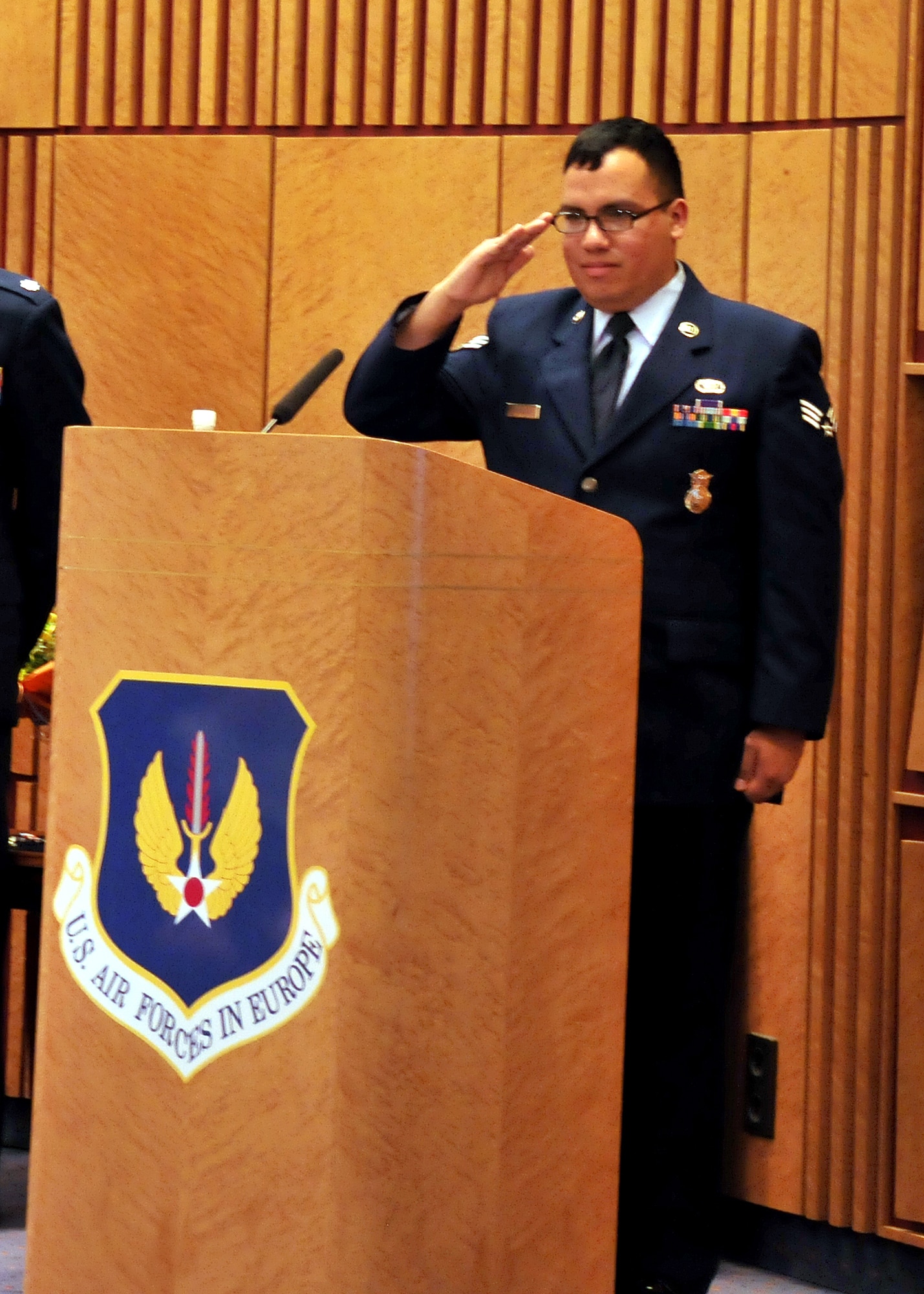Senior Airman Edgar Veguilla, 48th Security Forces Squadron, salutes the man who saved his life one year ago during a ceremony at Ramstein Air Base, Germany, March 2, 2012. Gen. Mark Welsh, U.S. Air Forces in Europe commander, presented Professor, Dr. Kai Zacharowski, the USAFE Medal of Distinction his role in saving the lives of Veguilla and Staff Sgt. Kristoffer Schneider, 48th SFS, who were critically injured during a shooting incident at the Frankfurt International Airport, Germany, March 2, 2011. (U.S. Air Force photo/Tech Sgt. Markus. M. Maier) (Released)