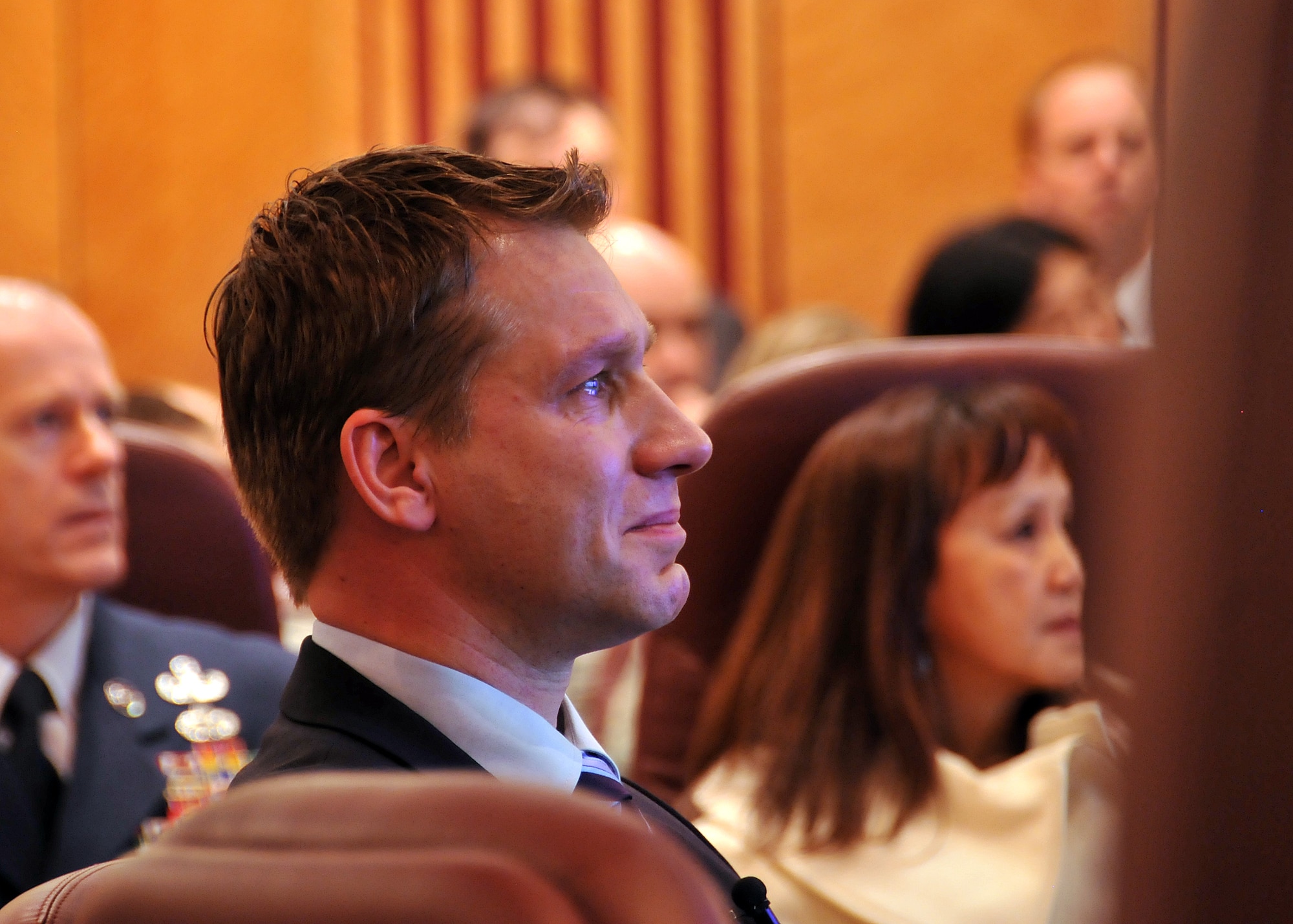 A visibly moved Dr. Zacharowski watches a video from Staff Sgt. Kristoffer Schneider, thanking the doctor for saving his life. German Professor Dr. Kai Zacharowski was presented the USAFE Medal of Distinction by Gen. Mark Welsh, U.S. Air Forces in Europe commander, during a ceremony at Ramstein Air Base, Germany, March 2, 2012.  Dr. Zacharowski was honored for his role in saving the lives of two USAFE Airmen who were critically injured during a shooting incident at the Frankfurt International Airport, Germany, March 2, 2011. (U.S. Air Force photo/Tech Sgt. Markus. M. Maier) (Released)