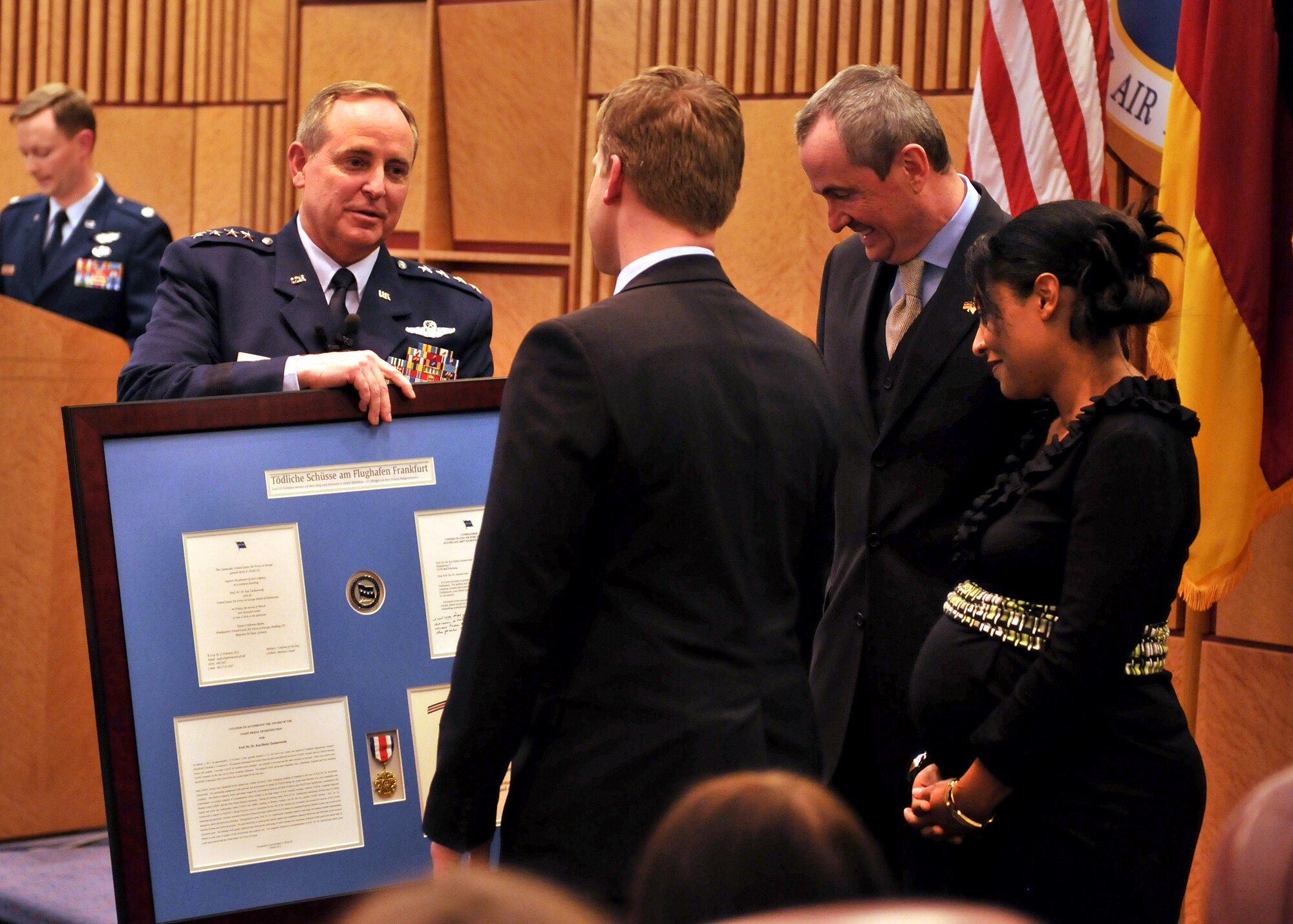 Gen. Mark Welsh, U.S. Air Forces in Europe commander, presents German Professor Dr. Kai Zacharowski the USAFE Medal of Distinction and citation during a ceremony at Ramstein Air Base, Germany, March 2, 2012. Dr. Zacharowski was honored for his role in saving the lives of two USAFE Airmen who were critically injured during a shooting incident at the Frankfurt International Airport, Germany, March 2, 2011. (U.S. Air Force photo/Tech Sgt. Markus. M. Maier) (Released)