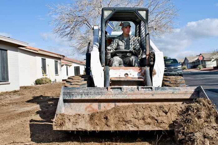 U.S. Air Force Senior Airman Brennen Bychinski, 99th Civil Engineer Squadron heavy equipment operator, uses a Bobcat T300 Compact Track Loader to move dirt, Feb. 14, 2012, near old base housing units at Nellis Air Force Base, Nev. The housing units were being extensively renovated and converted for use as temporary lodging facilities, to provide more space for families staying in base lodging during moves or travel. (U.S. Air Force photo by Airman 1st Class Matthew Lancaster)