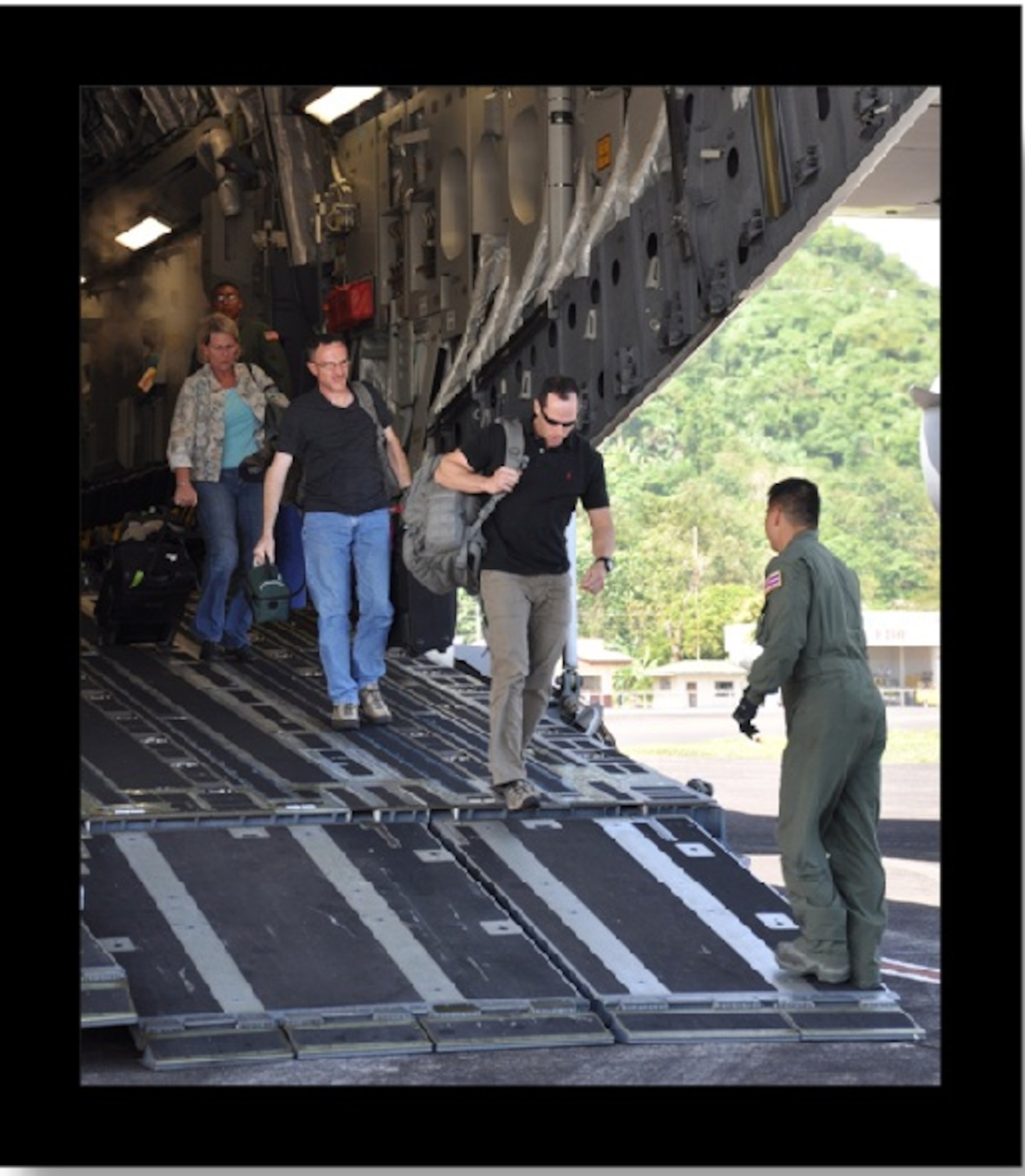 U.S. military members depart out the back of a C-17 Globemaster III aircraft March 1, 2012, at Legazpi International Airport, Legazpi City, Philippines. Ninety-eight U.S. military personnel, along with 35 Armed Forces of the Philippines members, 10 Philippine National Police members, as well as two Cambodian and one Tongan medical observers, are scheduled to participate in Operation Pacific Angel-Philippines, a joint and combined humanitarian assistance and civil military operations mission scheduled March 5 through 10. (U.S. Air Force photo by 1st Lt. Robert Howard)