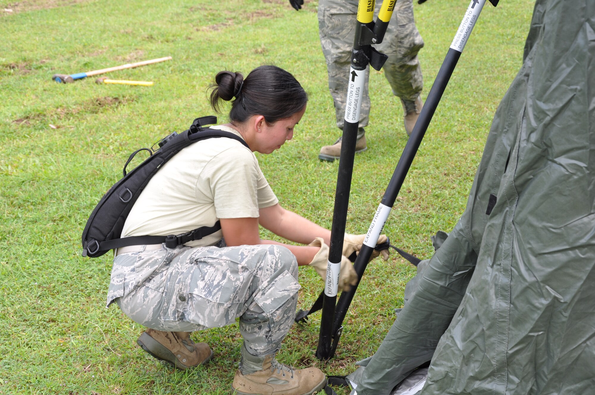 Staff Sgt. Rosalinda Mateo, 36th Medical Operations Squadron, secures ties to a tent during set-up on March 2, 2012. Pacific Angel-Philippines, a joint and combined humanitarian mission scheduled to begin March 5 at Tactical Operations Group 5, Legazpi City, Philippines. (U.S. Air Force photo by Lt. Robert Howard) 