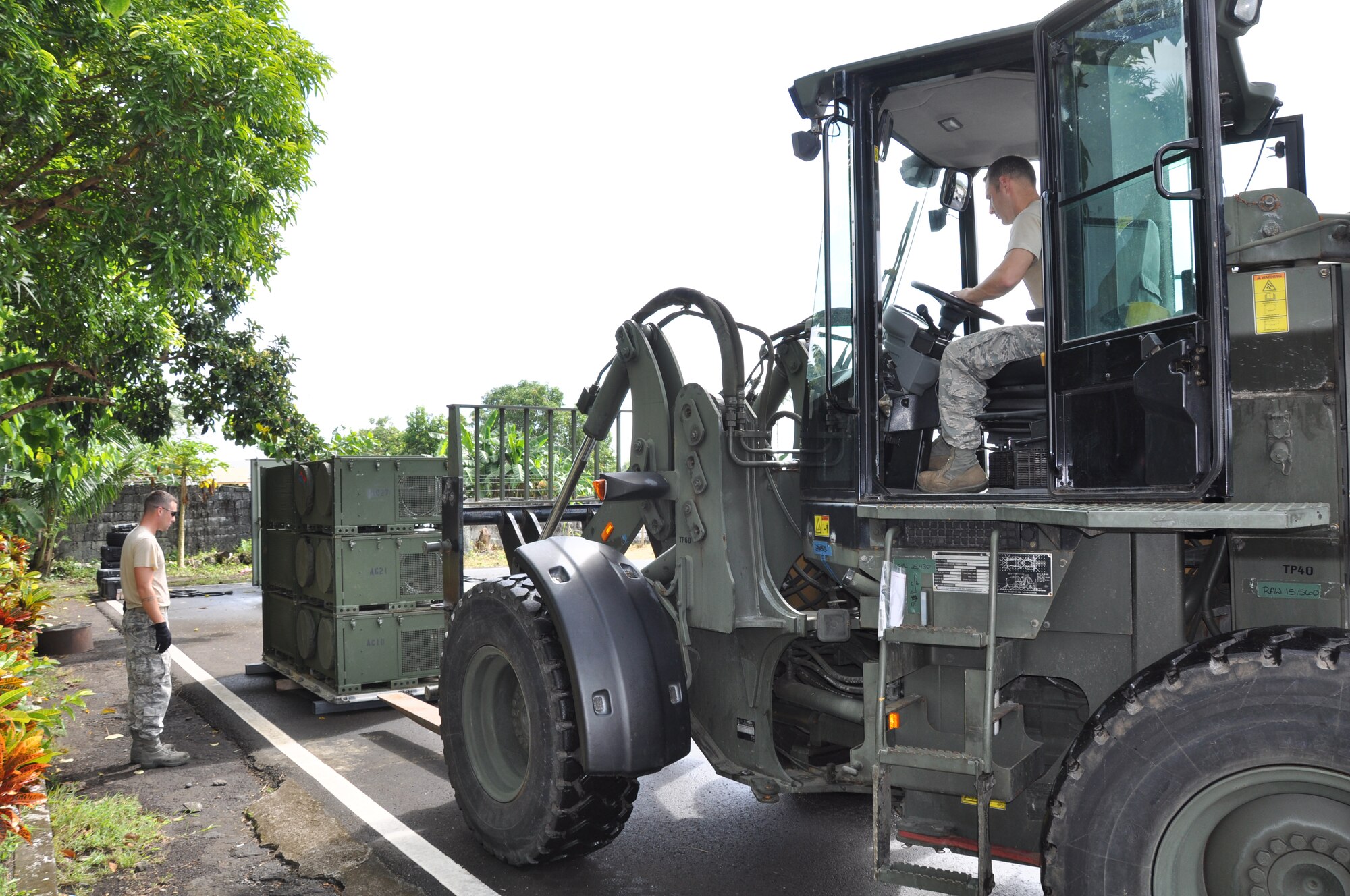 Master Sgt. Brady Redhage, 36th Mobility Response Squadron, non-commissioned officer in-charge  aerial port at Andersen Air Force Base, Guam, positions his forklift to move an air conditioning unit while Tech. Sgt. Joe Massey, 36th MRS aerospace ground equipment craftsman, spots him on March 2, 2012 for Pacific Angel-Philippines scheduled to begin March 5. The joint and combined humanitarian exercise will last six days at at Tactical Operations Group 5, Legazpi City, Philippines.  (U.S. Air Force photo by Lt. Robert Howard) 